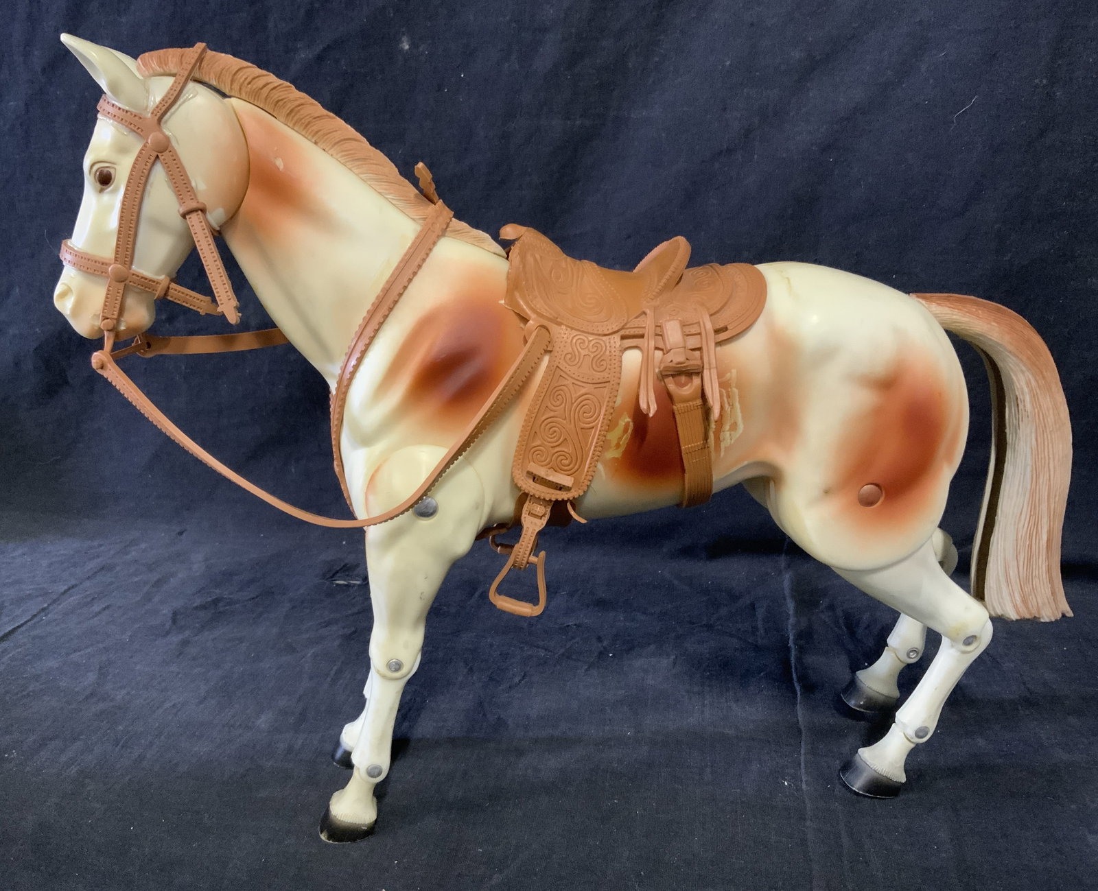 Articulated Poseable Horse Figural Toy 1ft1in: Articulated horse toy. Several joints allow the horse to be posed in various ways, toy is plastic, saddle and tail are rubber. Measures approx 10.75 inches H and 13 inches W. Wear is consistent with a