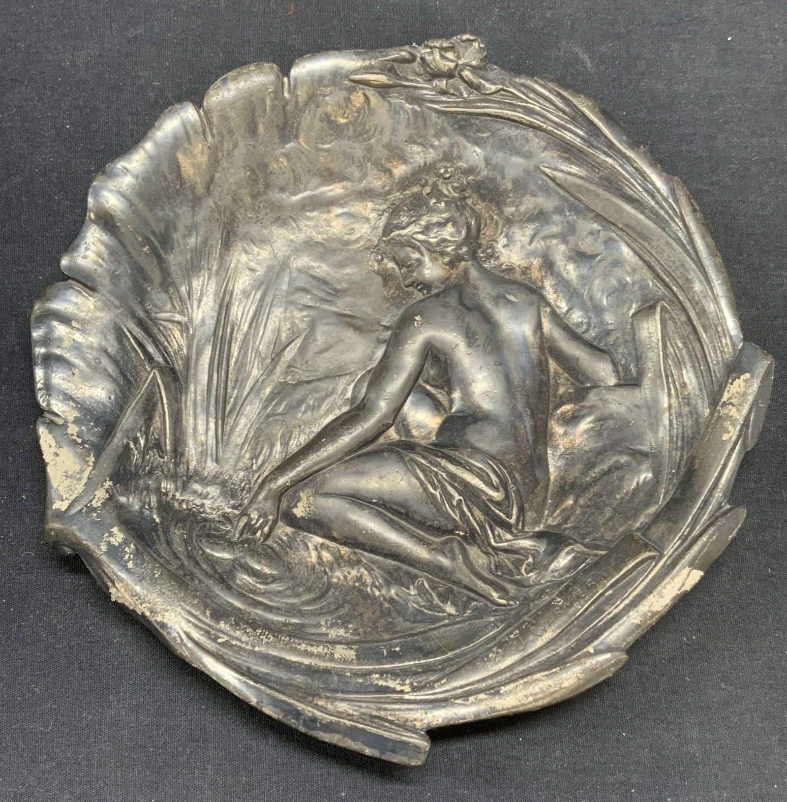 Antique Jean Garnier Silver Overlay Wall Plaque: Antique Jean Garnier silver overlaid wall plaque. Art nouveau style embossed nude female figural motif. Possibly pewter, piece is heavy. Measures approx. 9 inches diameter. Scratching and loss to over