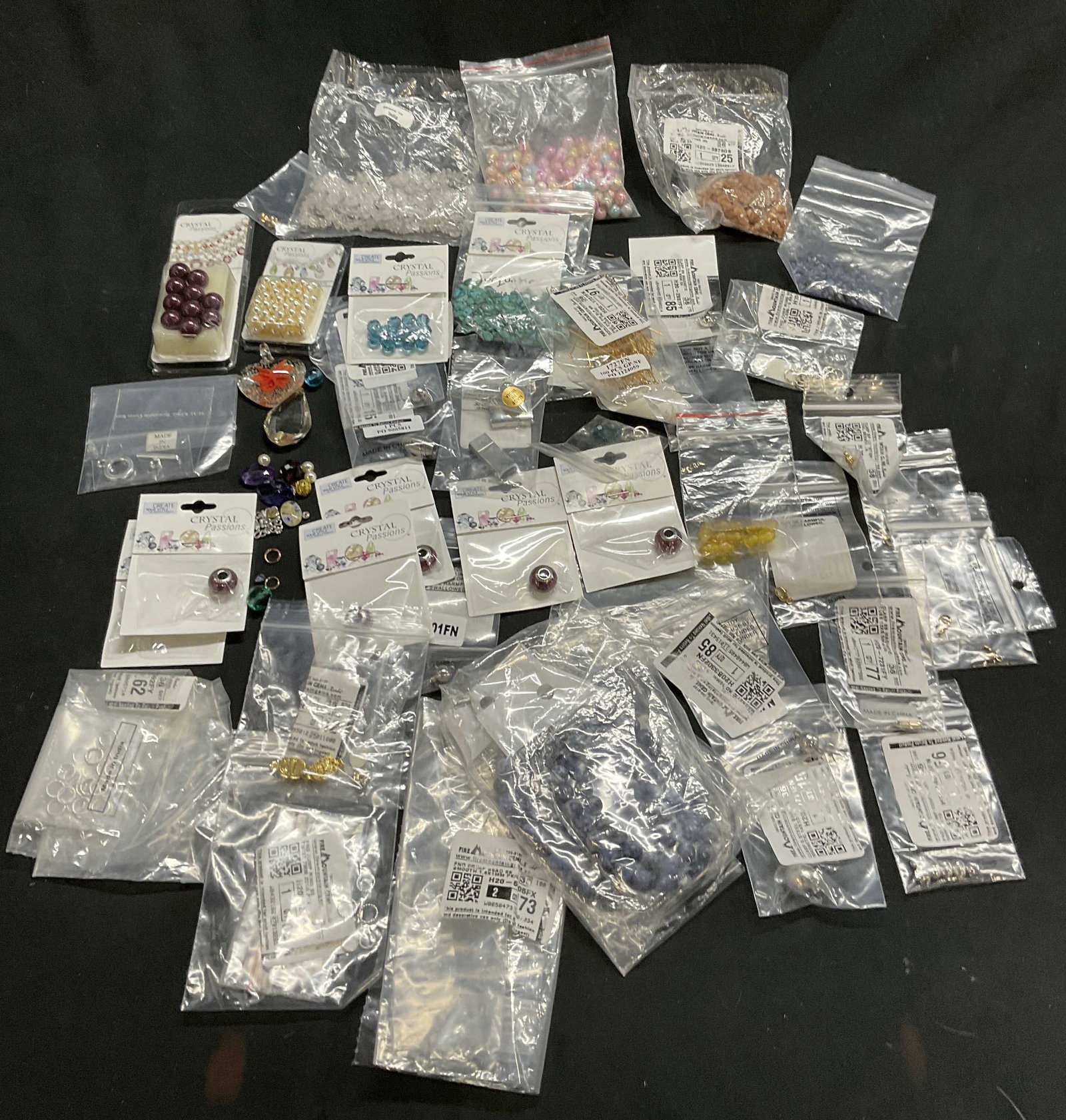 40 pkgs Jlry Makers Lot CRYSTAL PASSIONS and more: 40 pkgs. Jewelry Makers Lot in packaging includes CRYSTAL PASSIONS Swarovski Elements. Sunstone chips. Lobster Clasps, jump rings, crimp covers, crimp beads, magnetic steel barrel clasps, indicolite r