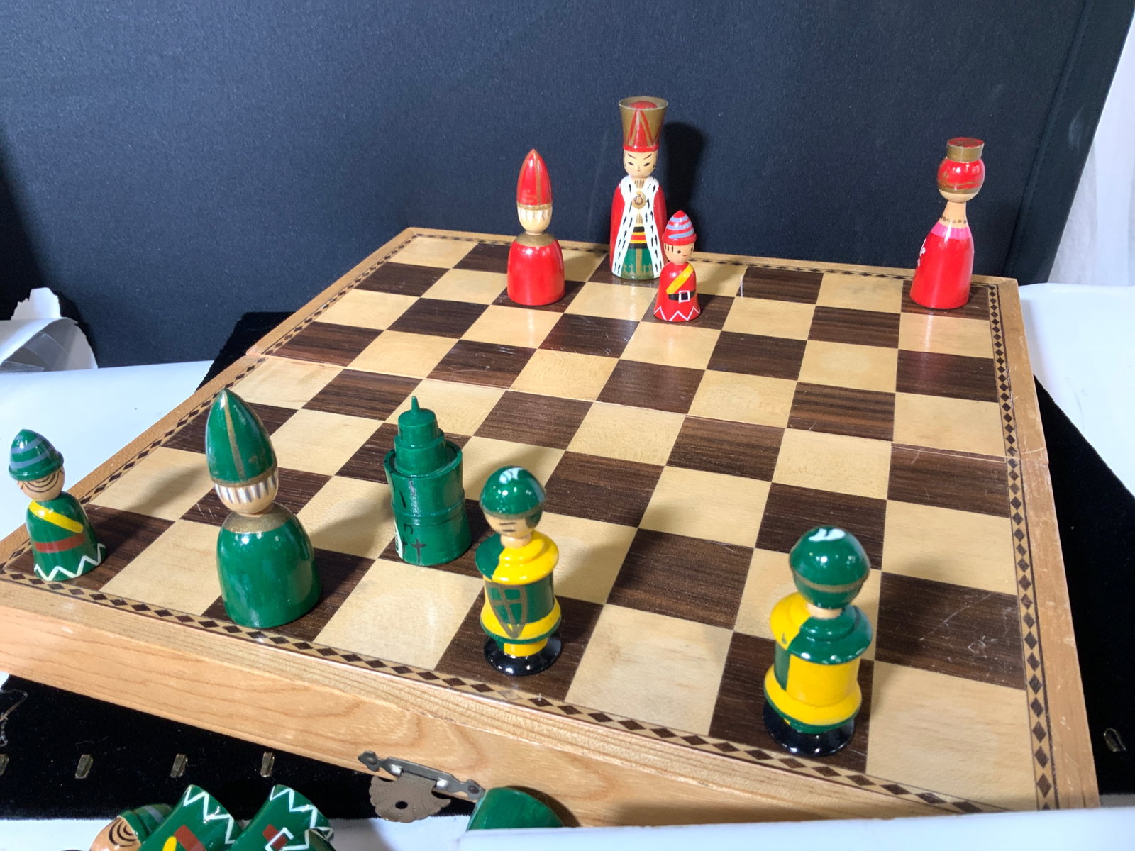 Collectible Wood Chess Board and Pieces, Japan: Handmade Foldable chess board with brass closure, hand painted chess wood pieces are kept inside. Chess pieces are handmade and hand painted, Japanese Human Figurals. Signed with label Gracefully Harm