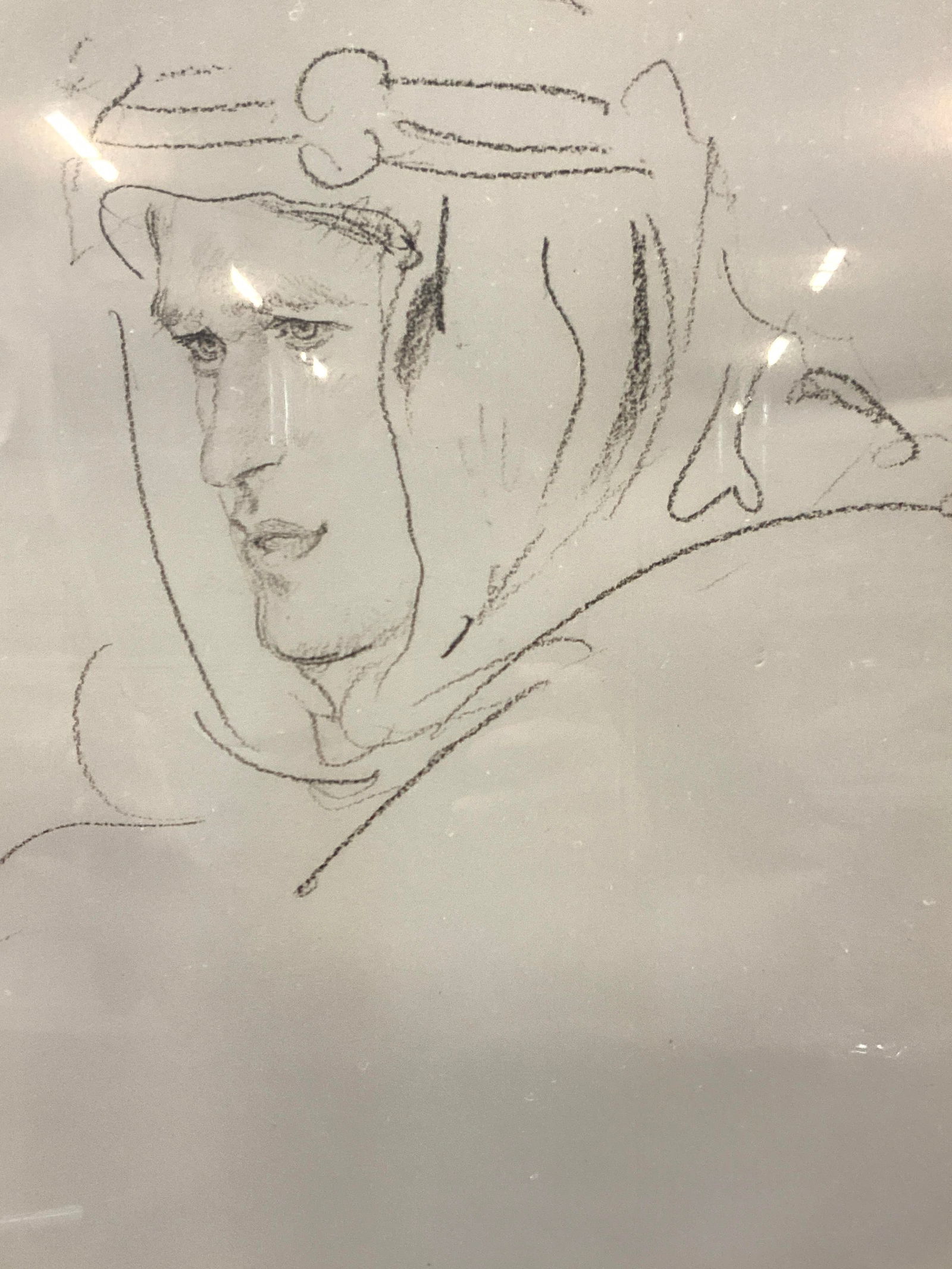 T.E.Lawrence, Lawrence of Arabia Lithograph: Lithograph of Lawrence of Arabia by Thomas Edward Lawrence. Depicting a hooded man in Arabian clothing. Framed in a black plastic fram and white mat board. Approx 20.5 x 16.5 inches window measures 14