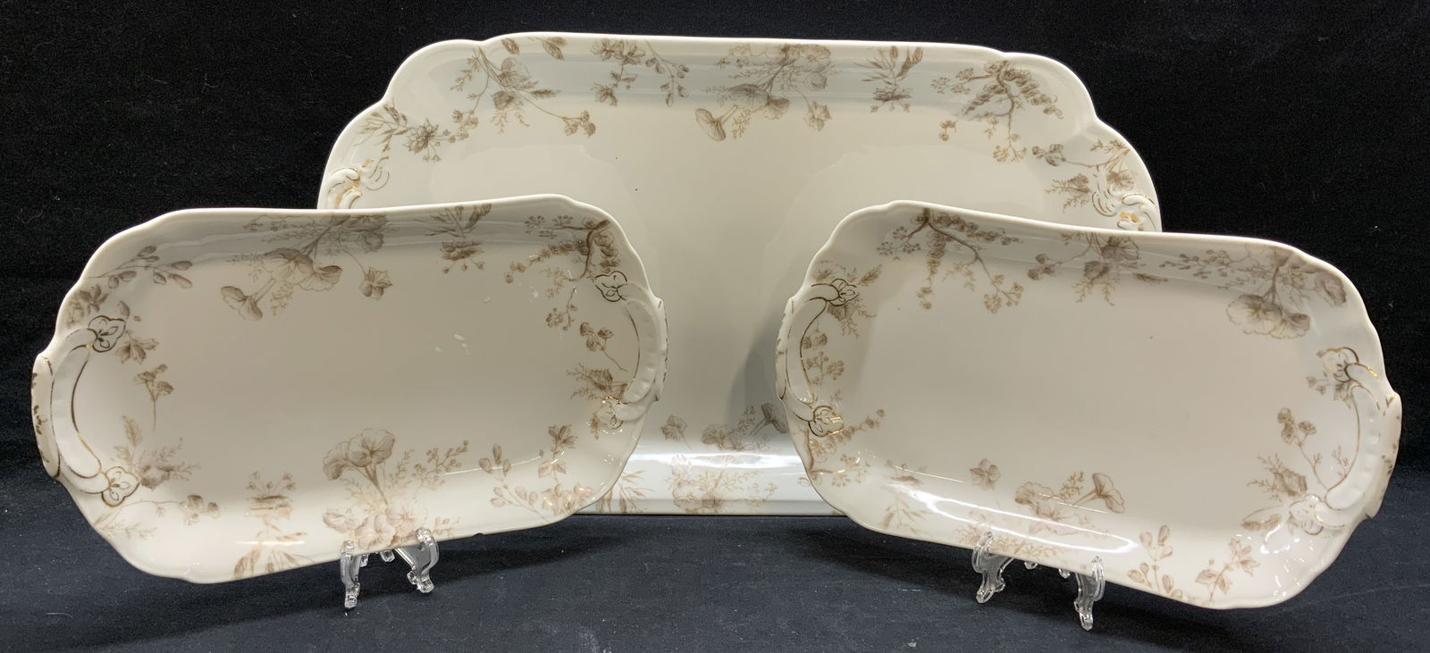 Set 3 Vintage T&V France Porcelain Platters: Set of 3 vintage, possibly antique, T&V France porcelain platters with brown floral motif. Trademarked to undersides. Some surface wear to all pieces consistent with exposure. Largest platter measures