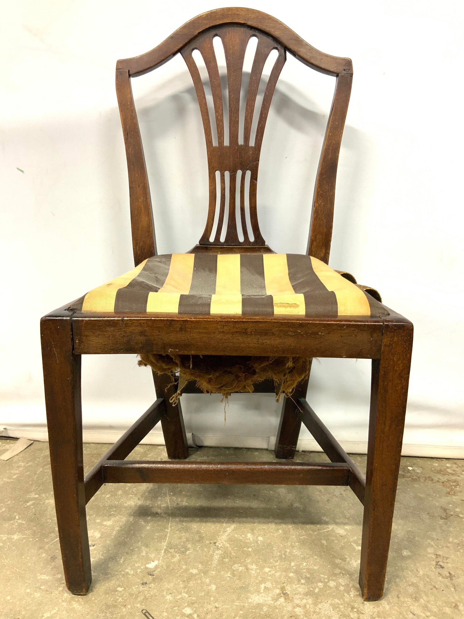 Vintage Carved Wooden Side Chair: Chair is vintage and wooden. Chair has pierced detail within backrest. Piece has beige & chocolate toned striped detail upholstery. Legs have stretchers in between. Chair measures approximately 36 inc