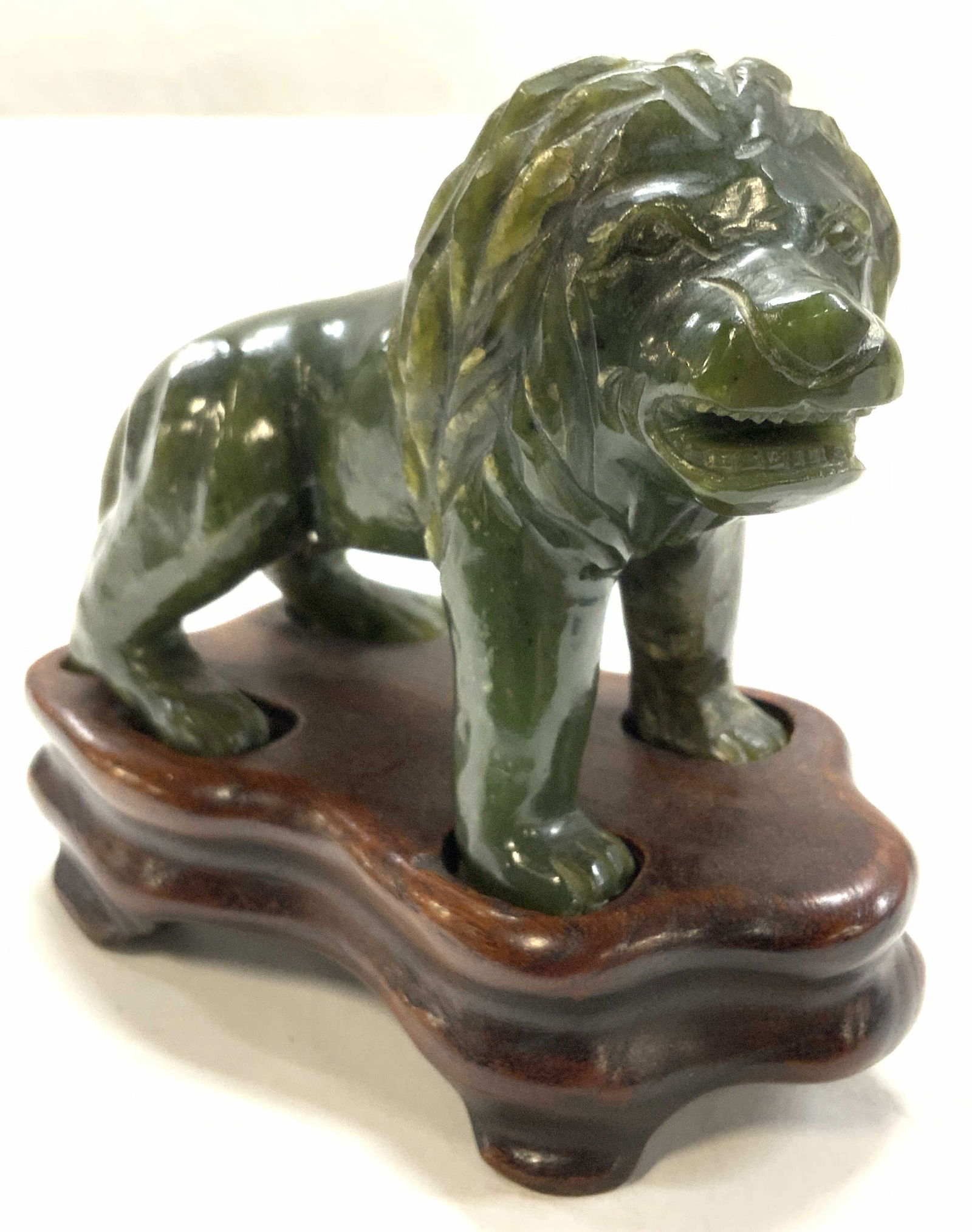 Green Moss Agate Lion Figural on Asian Stand: Carved dark green Quartz lion figural, green moss agate or possibly Jasper. Tests positive for the Quartz family on gem tester. Fits on a hand crafted Asian wood Base., lighter yellow - green coloring