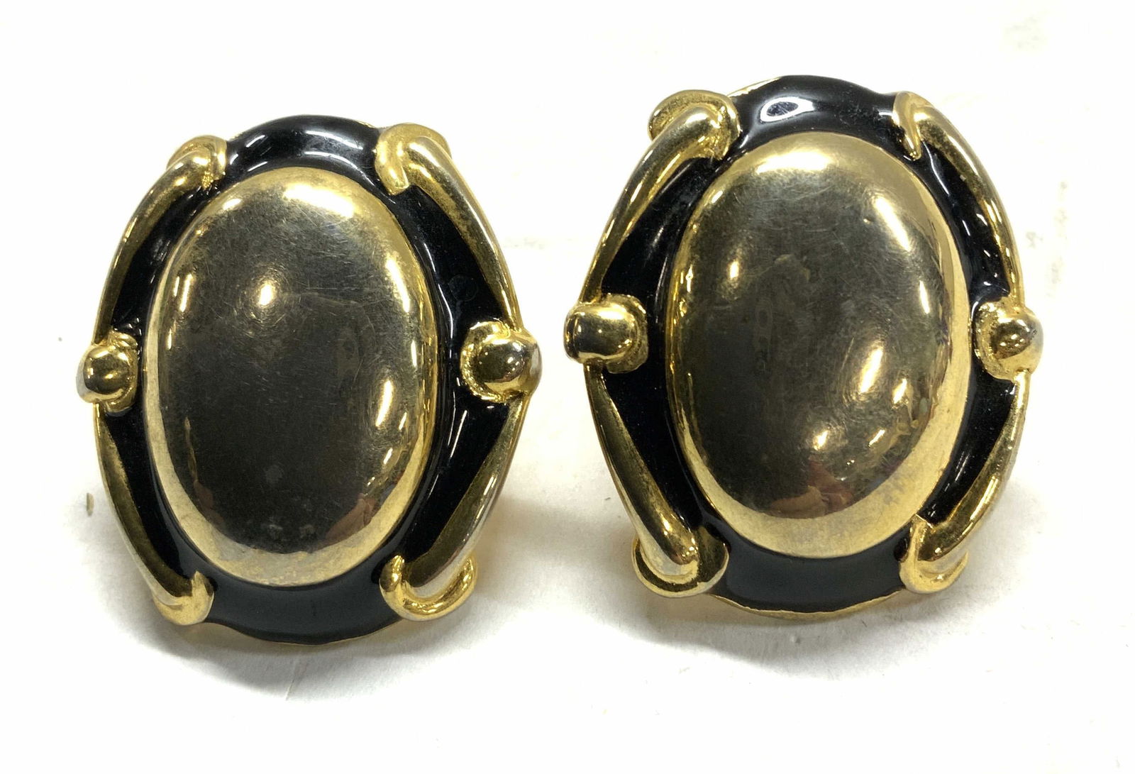 GIVENCHY Statement Clip Earrings in Gold Tn, Sgn: 1.5 x 1.25 in. GIVENCHY gold tone and black enamel clip on earrings. Hallmarked on verso. Light wear. GIVENCHY gold tone and black enamel clip on earrings, Chunky jewelry, French designer costume earr