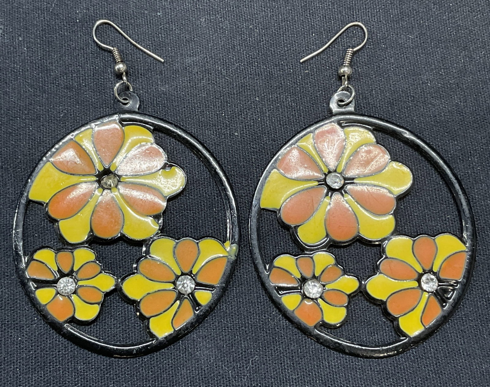 Vintage Enameled Crystal Flower Earrings: Vintage flower dangle earrings. Yellow and orange enamel with colorless crystal decoration. Hook backing. Measure approx. 2 inches diameter. One crystal needs replace, some scratching observed. Estate