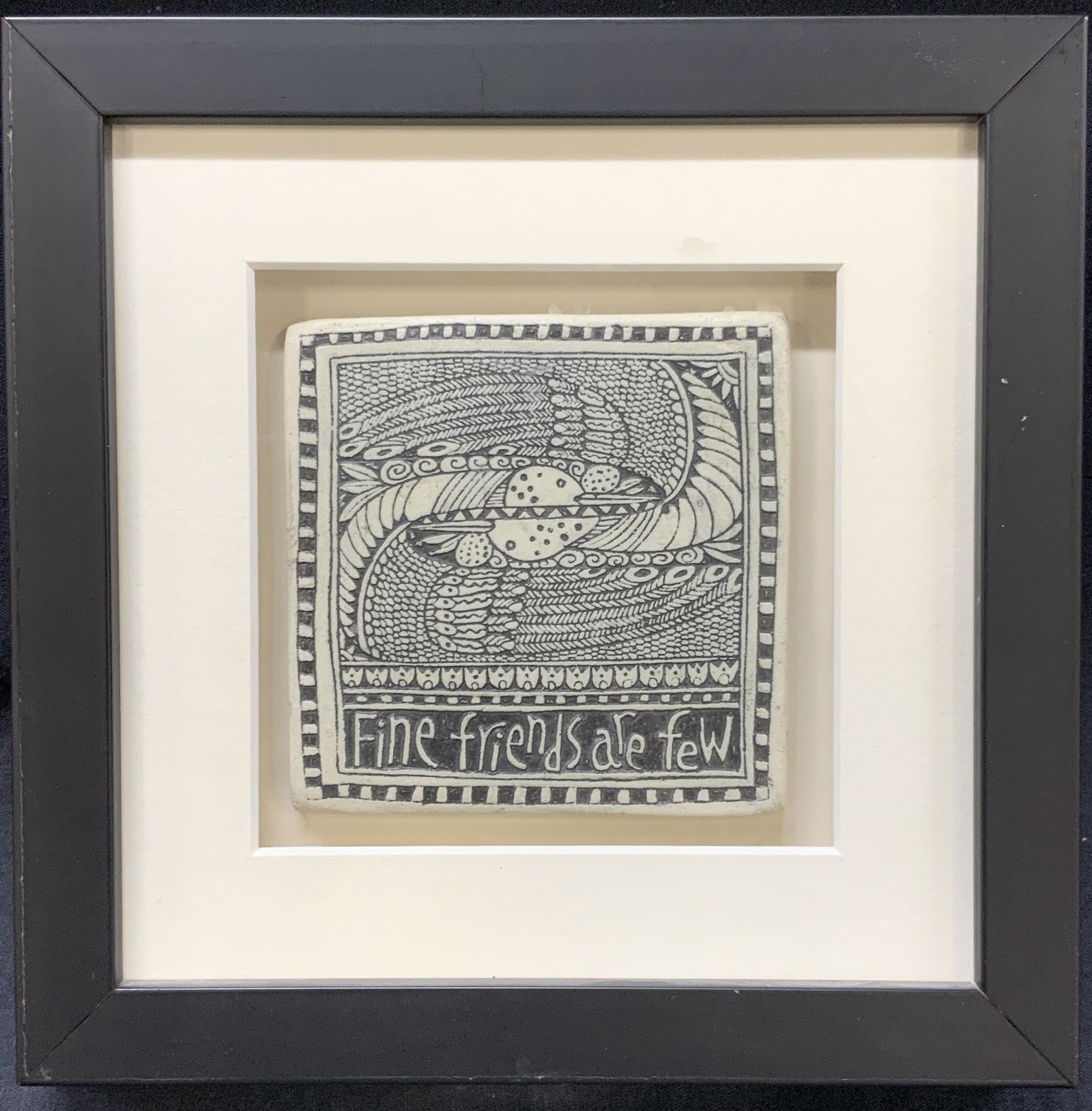Marsha McCarthy Fine Friends Are Few Tile Art: backside reads Drawings on clay, Marsha McCarthy. Tile reads Fine Friends are Few, and depicts two birds arching their necks towards each other with large wings. Framed in a black wooden frame with a