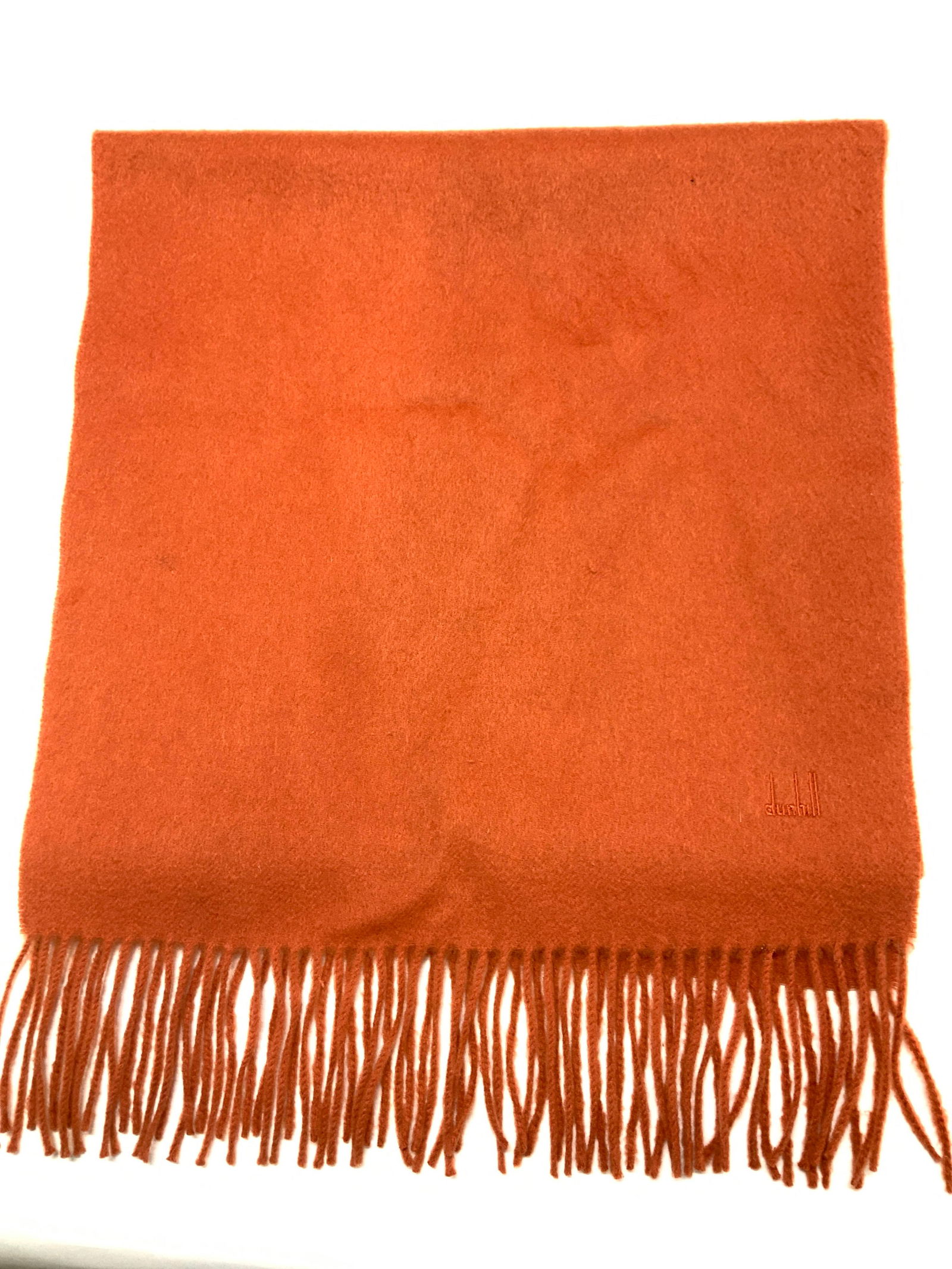 DUNHILL Cashmere Scarf, England: Orange tassel cashmere scarf, or shawl, marked Dunhill, label attached. Made in England. 100% cashmere. Has some wear to fabric including pin hole consistent with use, age, and exposure. Measures 15.7