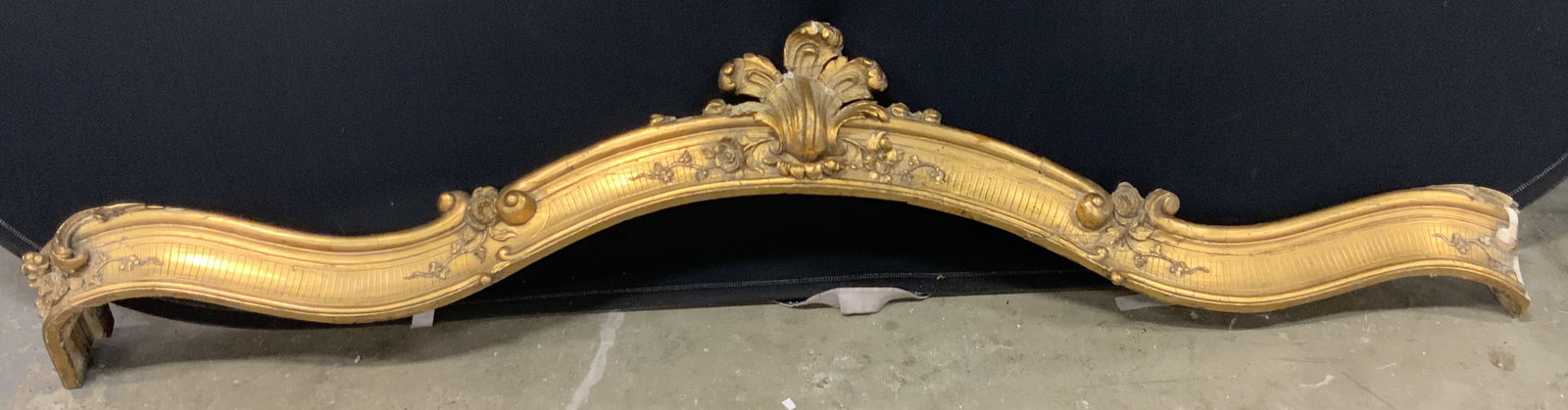 Antique Gilt Wood Carved Wood Arch 5ft11in: Antique carved wood arch. Gilt throughout the obverse. Measures approx. 71.5W x 9L in. Some plaster material to piece and some metal hardware to piece. Evident losses to piece, some cracking and chipp