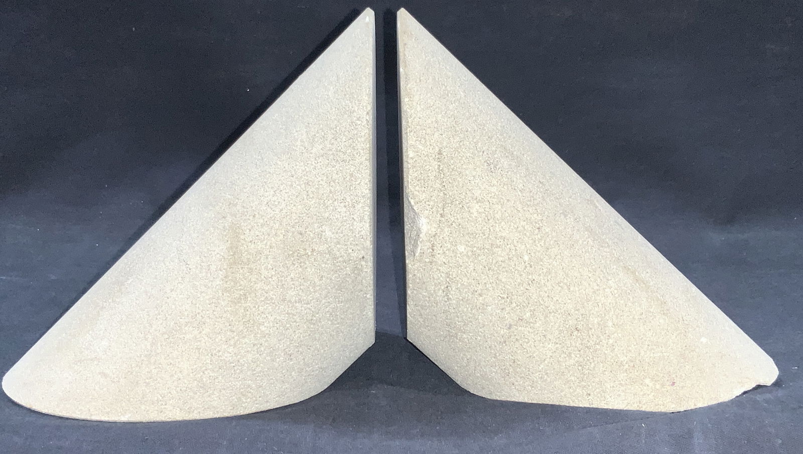 Pr Atelier International Cement Bookends, Italy: Pair of bookends, possibly made of cement, possibly stone. Marked on underside Sticker Atelier International Limited, made in Italy. Approx 6.25 inches tall and 7 inches long. Evident cracking and Los