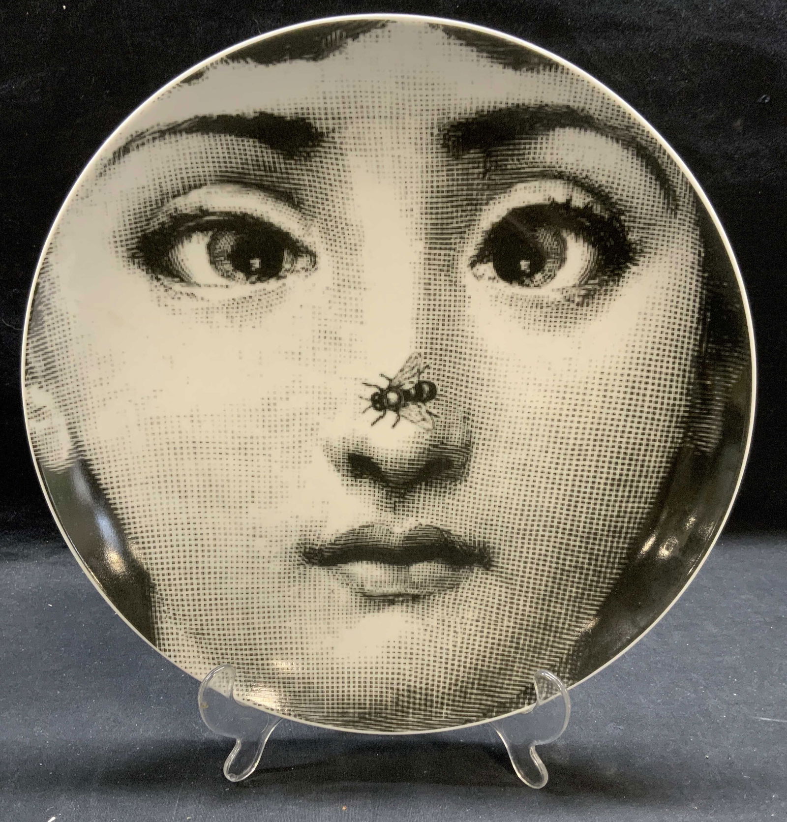 Fornasetti Porcelain Woman & Bee Plate: Fornasetti porcelain plate with head of a woman and bee. Signed to underside. Reads Fornasetti x J & J, May 2, 2020. Measures approx. 12 inches diameter. Minor scratches observed. Fornasetti, Fornaset
