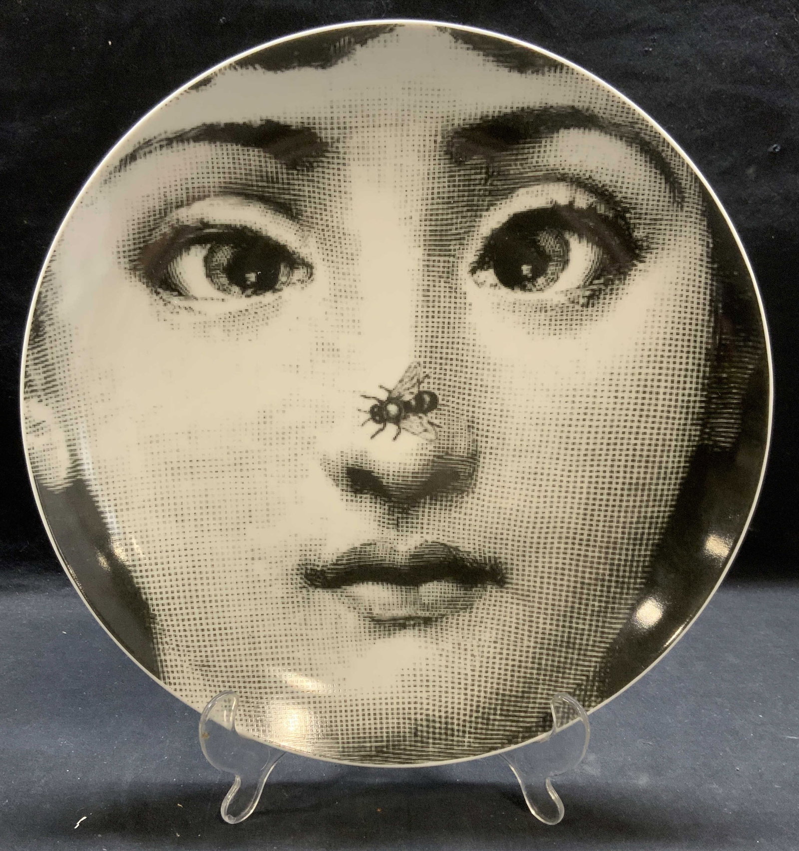 Fornasetti Porcelain Woman & Bee Plate: Fornasetti porcelain plate with head of a woman and bee. Signed to underside. Reads Fornasetti x J & J, May 2, 2020. Measures approx. 12 inches diameter. Minor scratches observed. Fornasetti, Fornaset