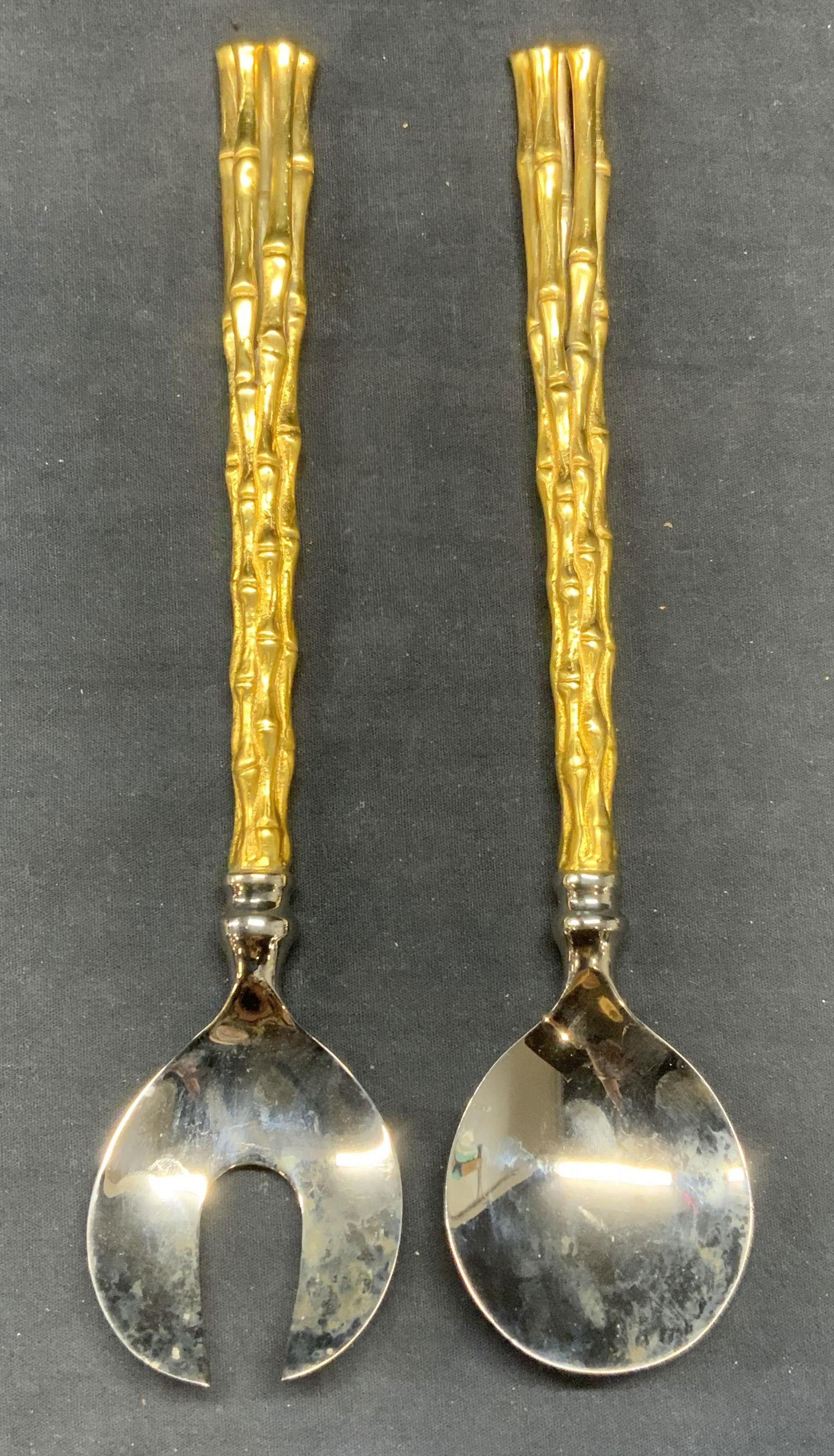 2pcs L Objet 24K Gold Plated Salad Serving Set: L Objet 24K gold plated handle salad serving utensil set with sculptural bamboo motif handles. Pieces have weight. Trademarked to undersides. Measures approx. 11.5 inches long each. Both pieces have s