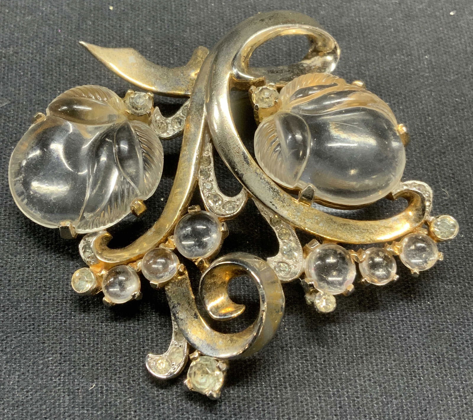 MAZER Art Deco Silver Tn Lucite Peach Brooch: Mazer art deco silver tone and gold plated brooch with transparent Lucite peach motif and colorless crystal decoration. Signed to underside. Hinge pin to underside. Measure approx. 2.25 x 2.25 inches.