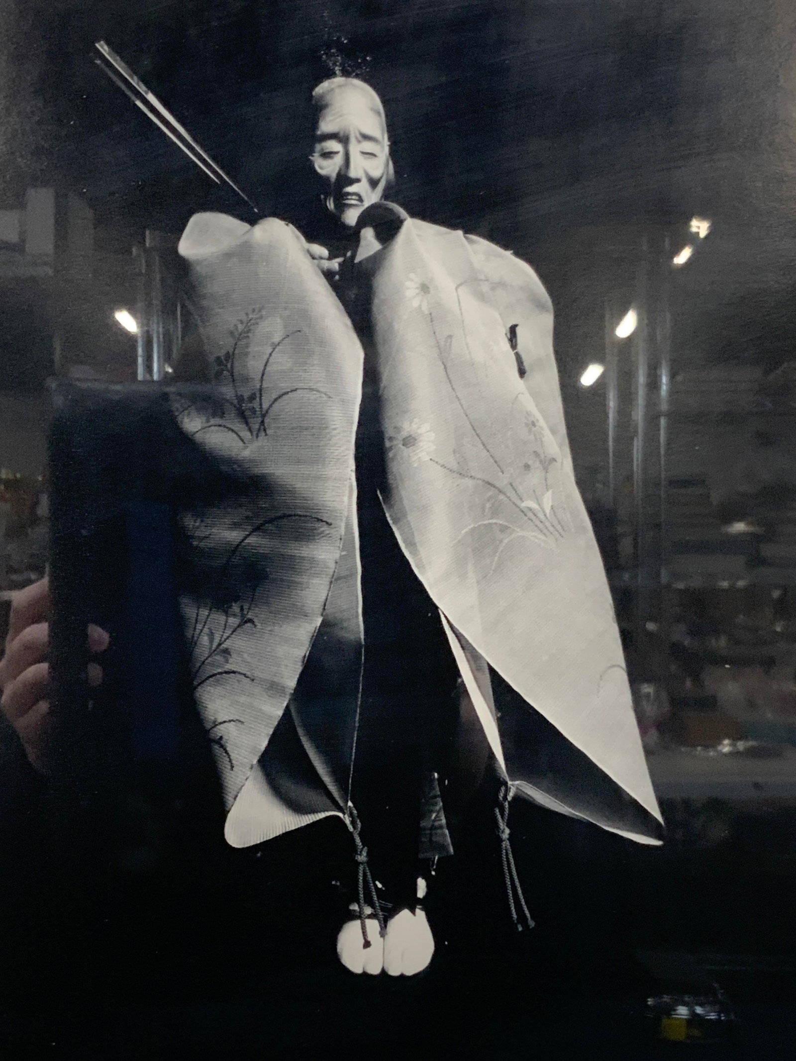 IKKO Narahara Sgd Japanese Doll Photograph: Signed on lower right corner in graphite, Ikko Depicts a black and white image of Japanese doll with porcelain face and fabric kimono Framed in a silver toned metal frame with off white mat boards app