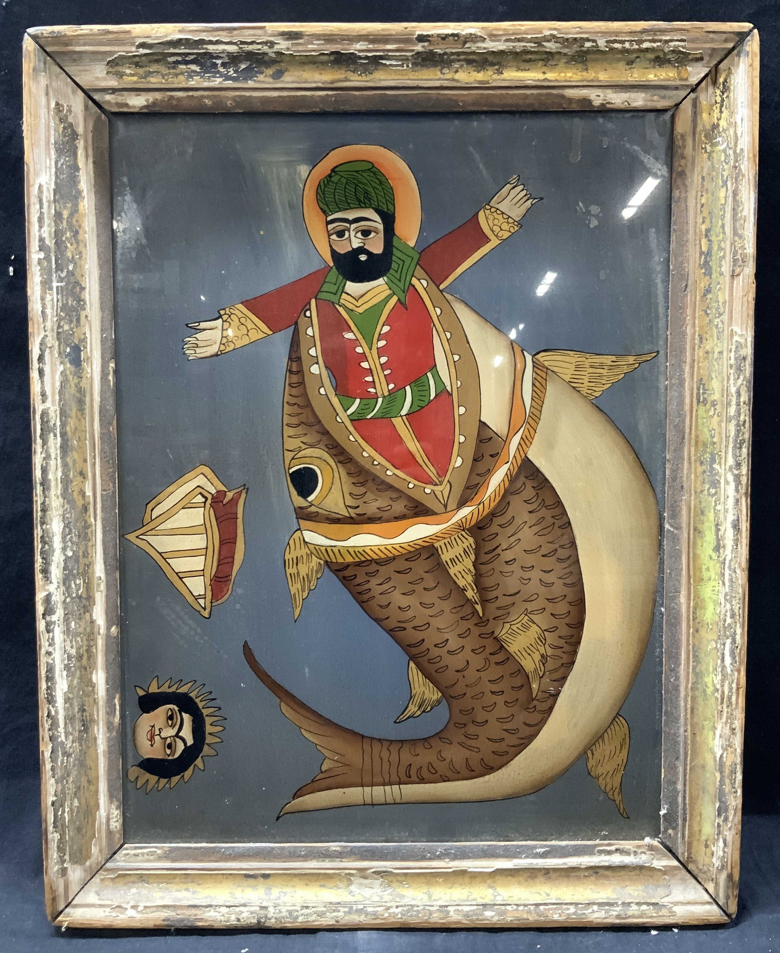 Vntg Iranian Folk Art Reverse Painting On Glass: Vintage reverse glass painting depicting a man in red robes being eaten by a large fish on a blue background with the head of woman on lower left. Possibly a depiction of the Jonah being swallowed by 