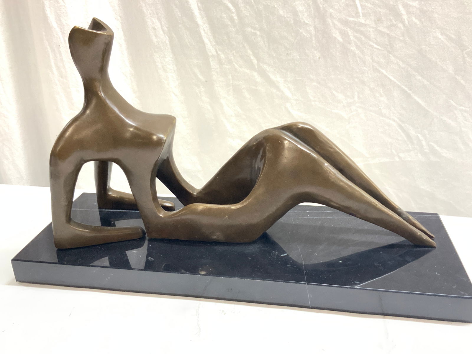 HENRY MOORE Sgd Bronze Reclining Figure III 1ft8in: Signed on arm of figure H. Moore. Figure possibly made of solid bronze, affixed to a black marble Base, evident weight. Approx 11 inches tall and 20 inches long, with base being 20 inches long and 7.5