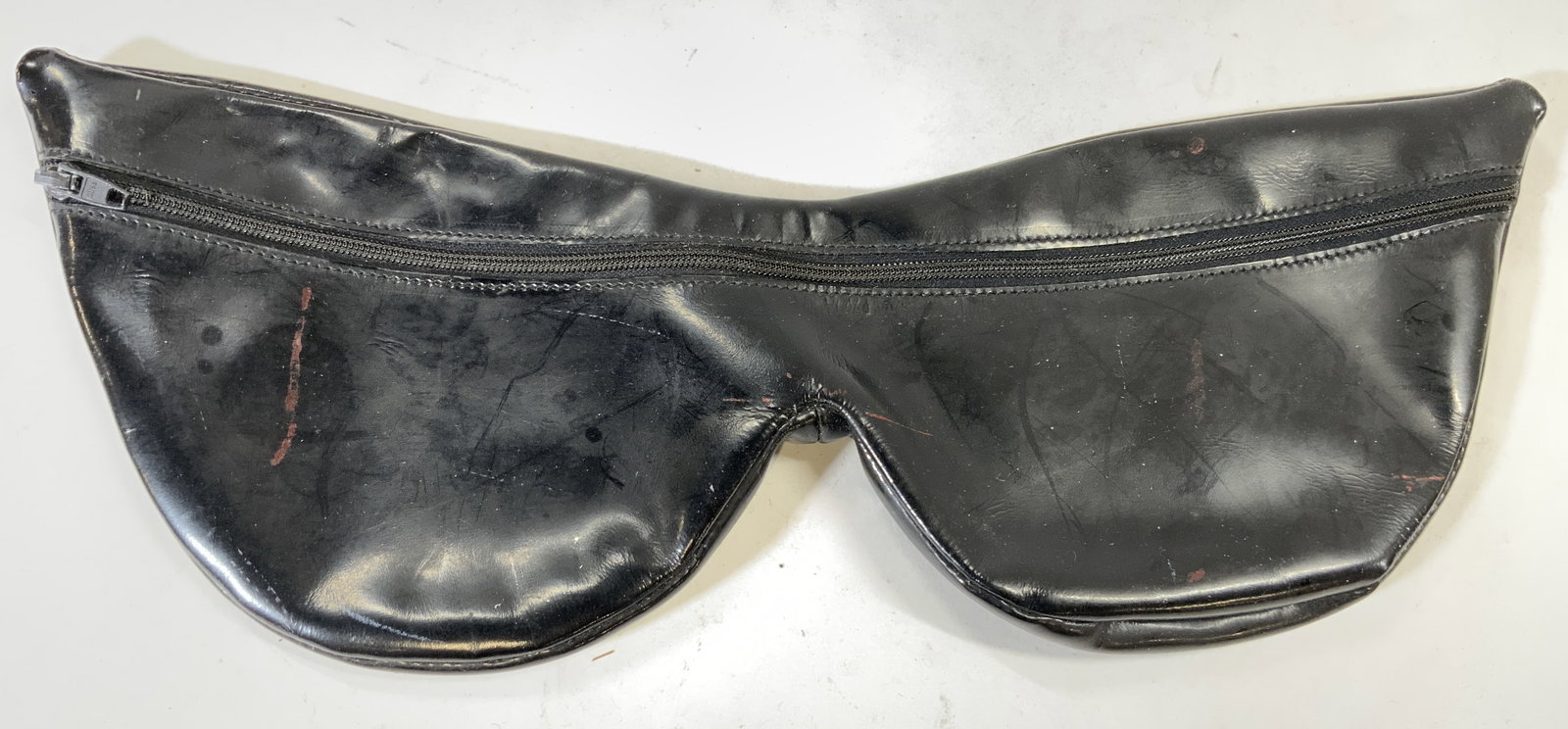 JEAN LOUISEMBERT Sunglass Patent Leather Pouch: Interior reads JEAN LOUISEMBERT FRANCE. Pouch is in the shape of a pair of sunglasses. Piece is black toned patent leather. Pouch has one zipper pocket area. Piece measures approximately 15 inches lon