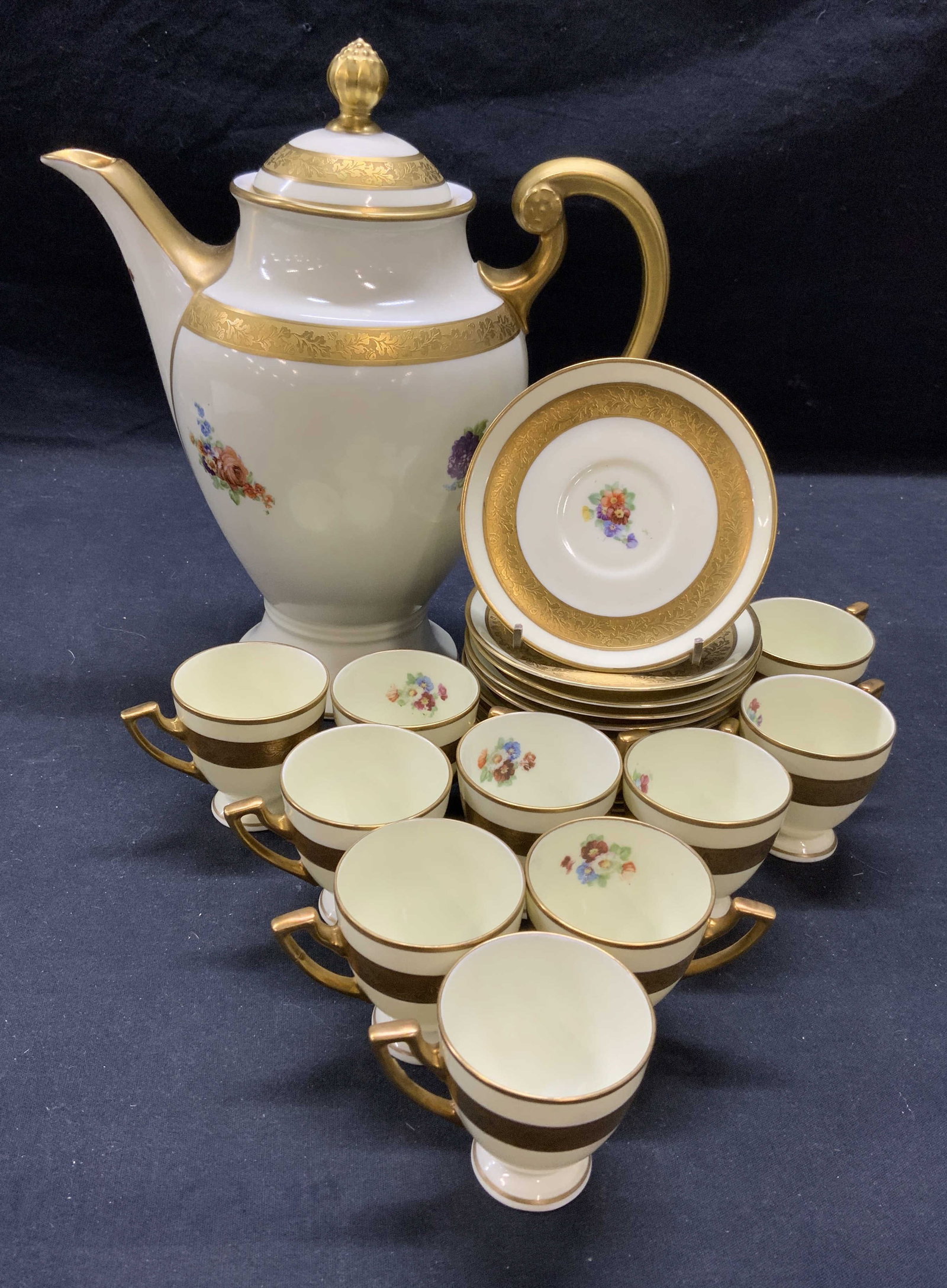 HUTSCHENREUTHER Bavaria Porcelain Coffee Pot, More: Set of 23 pieces. HUTSCHENREUTHER Bavaria porcelain coffee pot with gilt decoration and floral motif. Matching demitasse cups and saucers. 10 cups and 12 saucers. Trademarked HUTSCHENREUTHER to unders