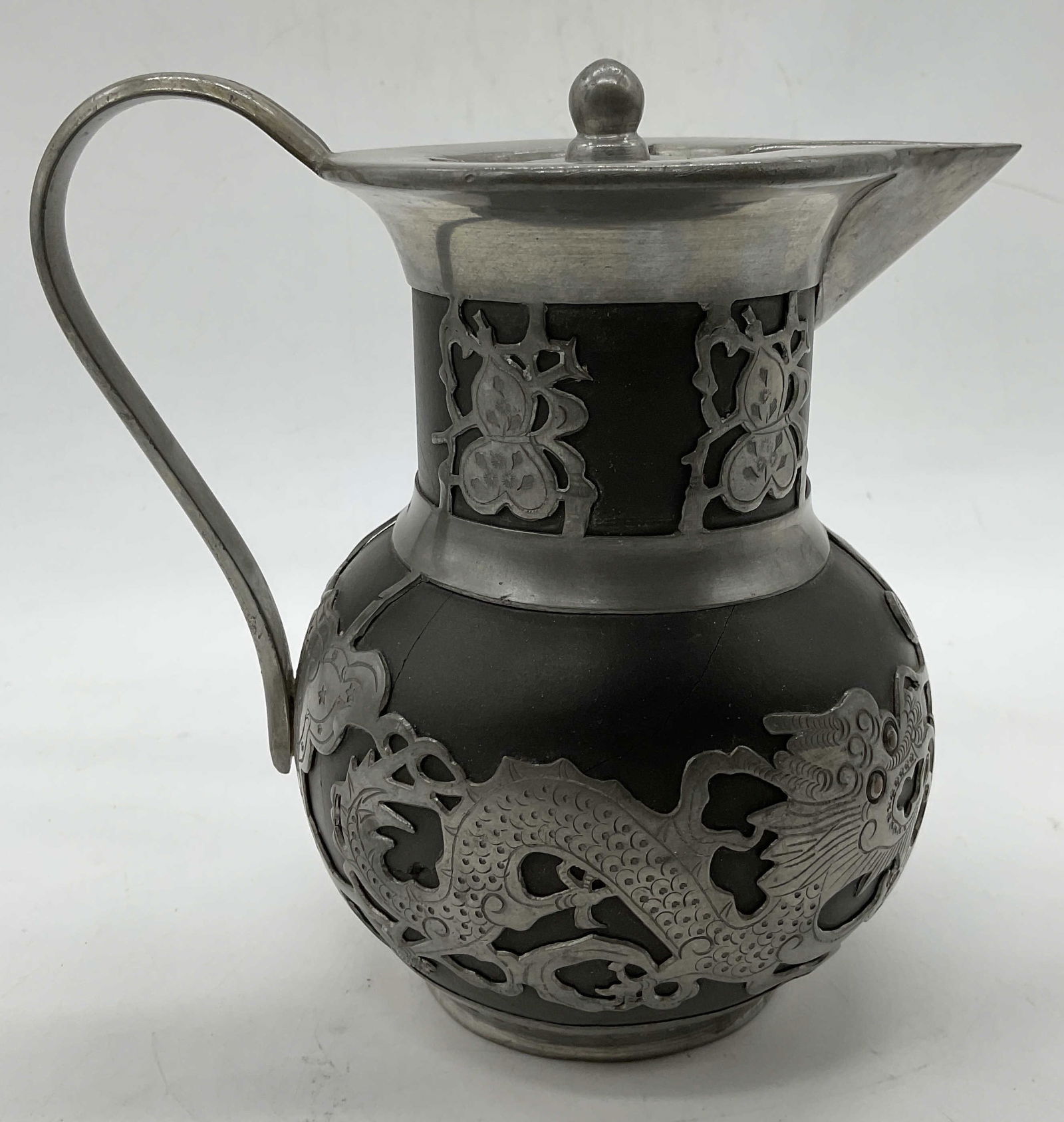 Vintage Terracotta w/ Pewter Mount Yi Xing Teapot: Vtg Terracotta w/ Pewter Mount Yi Xing Teapot with lid. Stamp on base reads: Made by Swang Shing Hing. Wei-Hai-Wei. Measures approx. 5.25H x 6W in. Some surface wear consistent with age, and use. Some