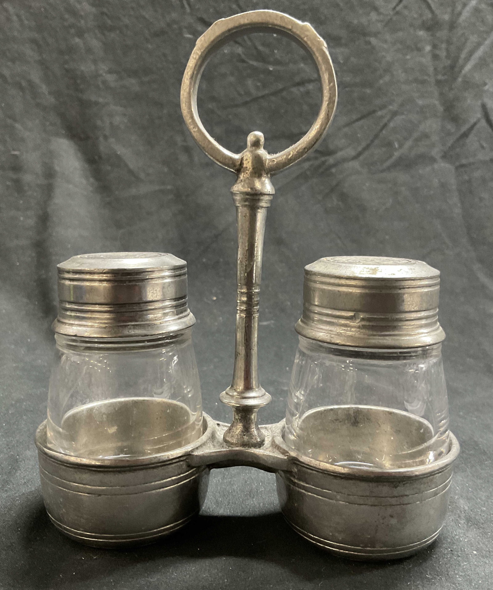 ARTE ITALICA Tavola Salt & Pepper Shakers W/ Caddy: ARTE ITALICA Tavola Pewter Glass Salt & Pepper Shakers with Caddy. Made in Italy. Measures approx. 5W x 6H in. Some surface wear consistent with age, and use. Some surface residue. Salt and pepper sha