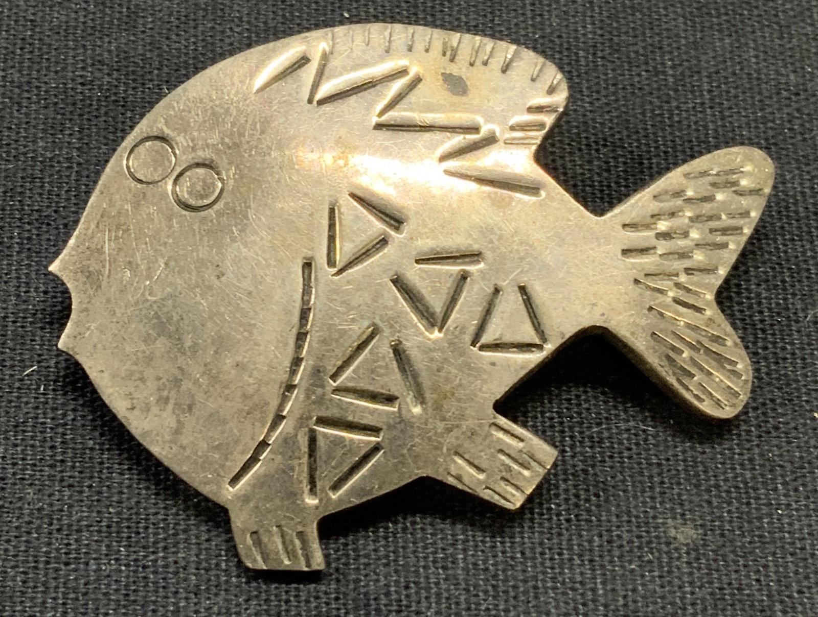 Sterling Silver Etched Fish Brooch, Mexico: Sterling silver etched fish brooch. Hinge pin to underside. Marked 925, Mexico to underside. Measures approx. 2 x 1 3/8 inches. Some surface wear consistent with exposure. Total weight .64 ozt. Estate