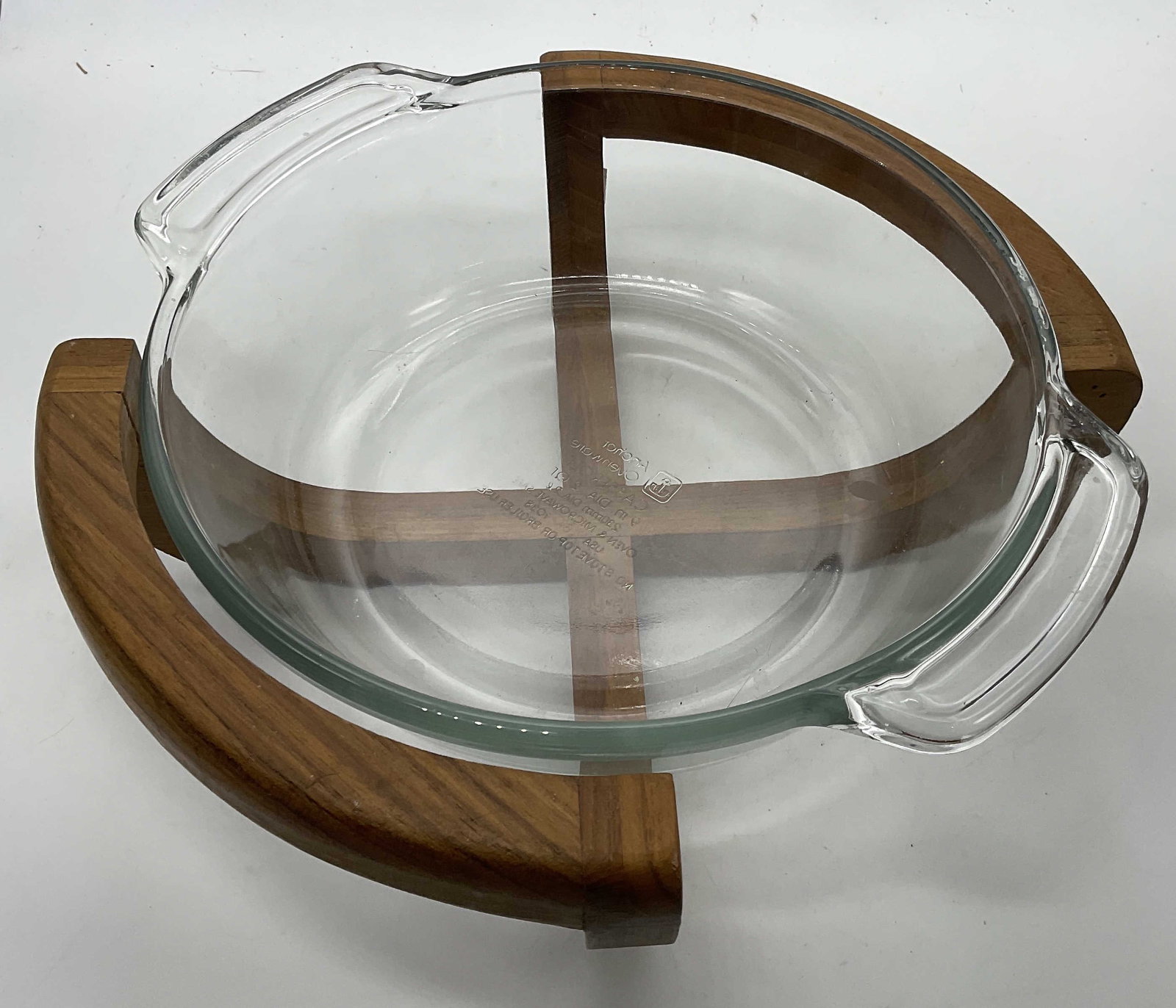 MCM Anchor Ovenware Casserole Dish W/ Wood Cradle: Vtg MCM Anchor Ovenware 2Q Glass Bowl W/ Teakwood Cradle. Cradle made in Thailand. Glass bowl made in USA. Measures 11W in. Some surface wear consistent with age, and use. MCM tabletop decor, Anchor O