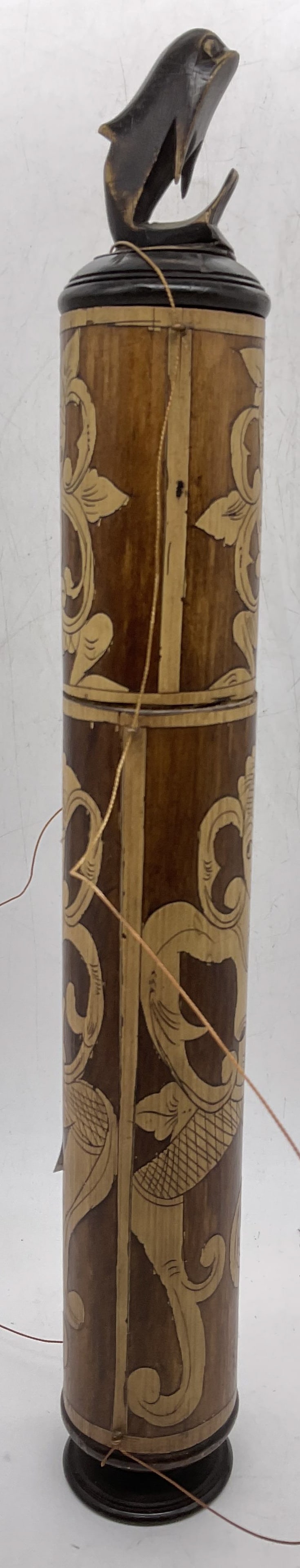 Carved Bamboo Lidded Lime Container 1ft5in: Carved Bamboo Lidded Lime Container. Measures approx. 17.25H x 2.5W in. With fish / whale / dolphin figural finial. Body of container decorated with dancing nude figural motif. Some surface wear consi