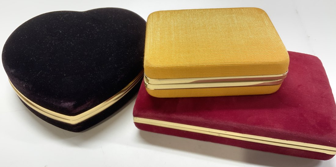 Lot of 3 Dresser Jewelry Boxes, Munda, Mele: Jewelry boxes for dresser top , drawer, or travel., 2 are velour - heart shape black velour , 6 x 6.25 in. Red velour signed MELE , 7 x 4.5 in. Yellow ribbed fabric signed Mundi with an attached cinch