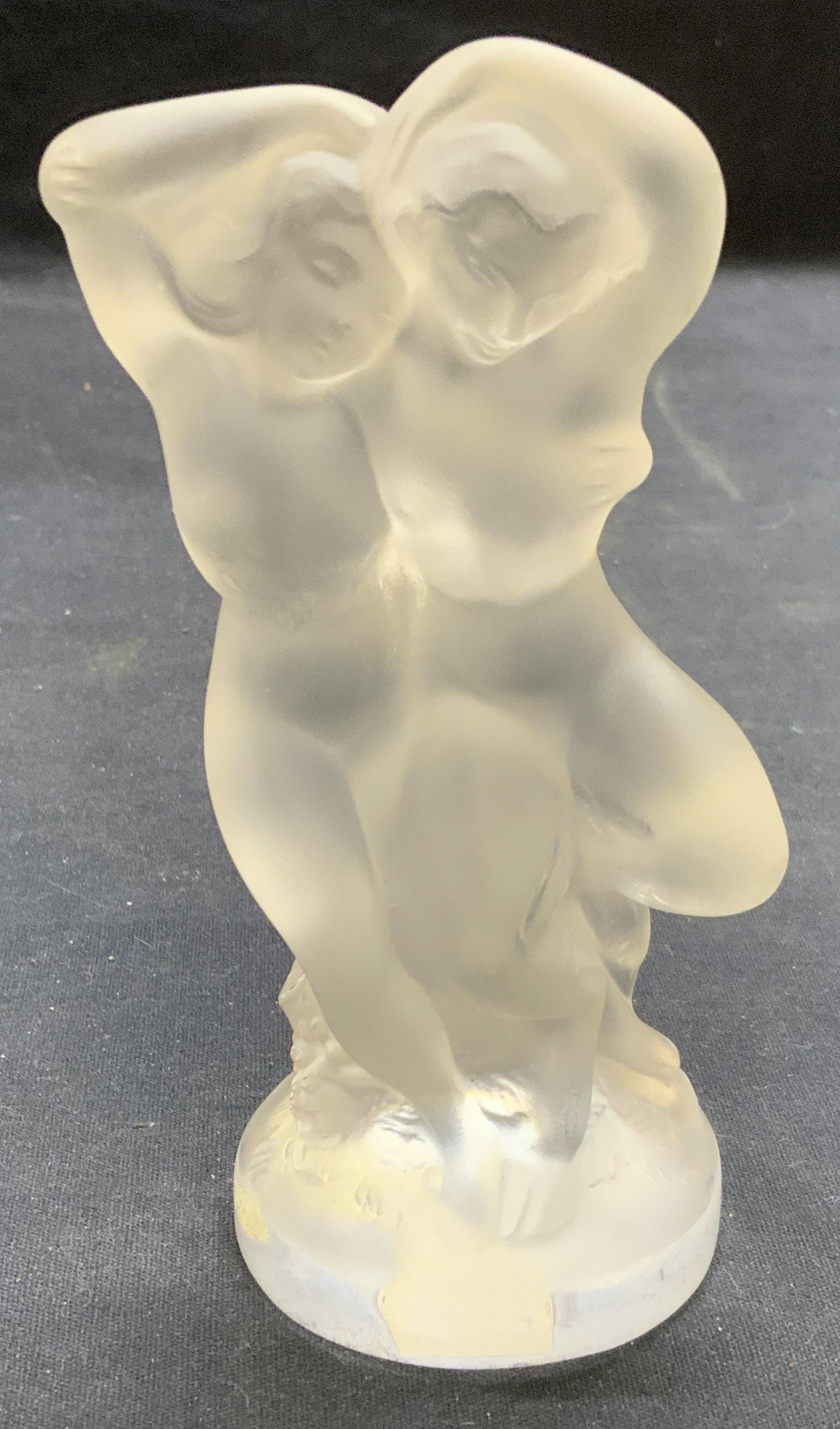 Lalique Crystal Woman & Faun Figurine, France: Lalique crystal nude woman and faun figurine. Signed along base and underside. Made in France. Measures approx. 5.5 x 2.5 inches. Piece has weight. Some surface wear including scratching observed. Lal
