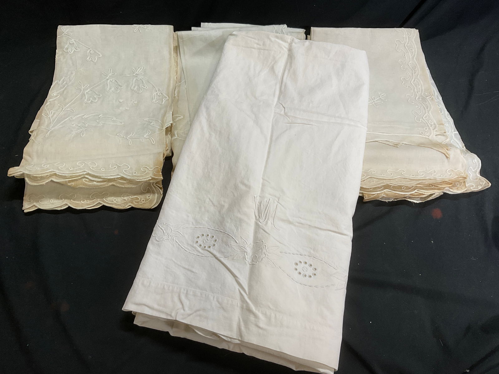 Lot 13 Vintage Linen and Cotton Tablecloths: Lot 13 Vintage Linen and Cotton embroidered Tablecloths. Some surface wear consistent with age, and use. Some discoloration present. Cotton tablecloth has WM monogram. Linen Tablecloths measure 28W x