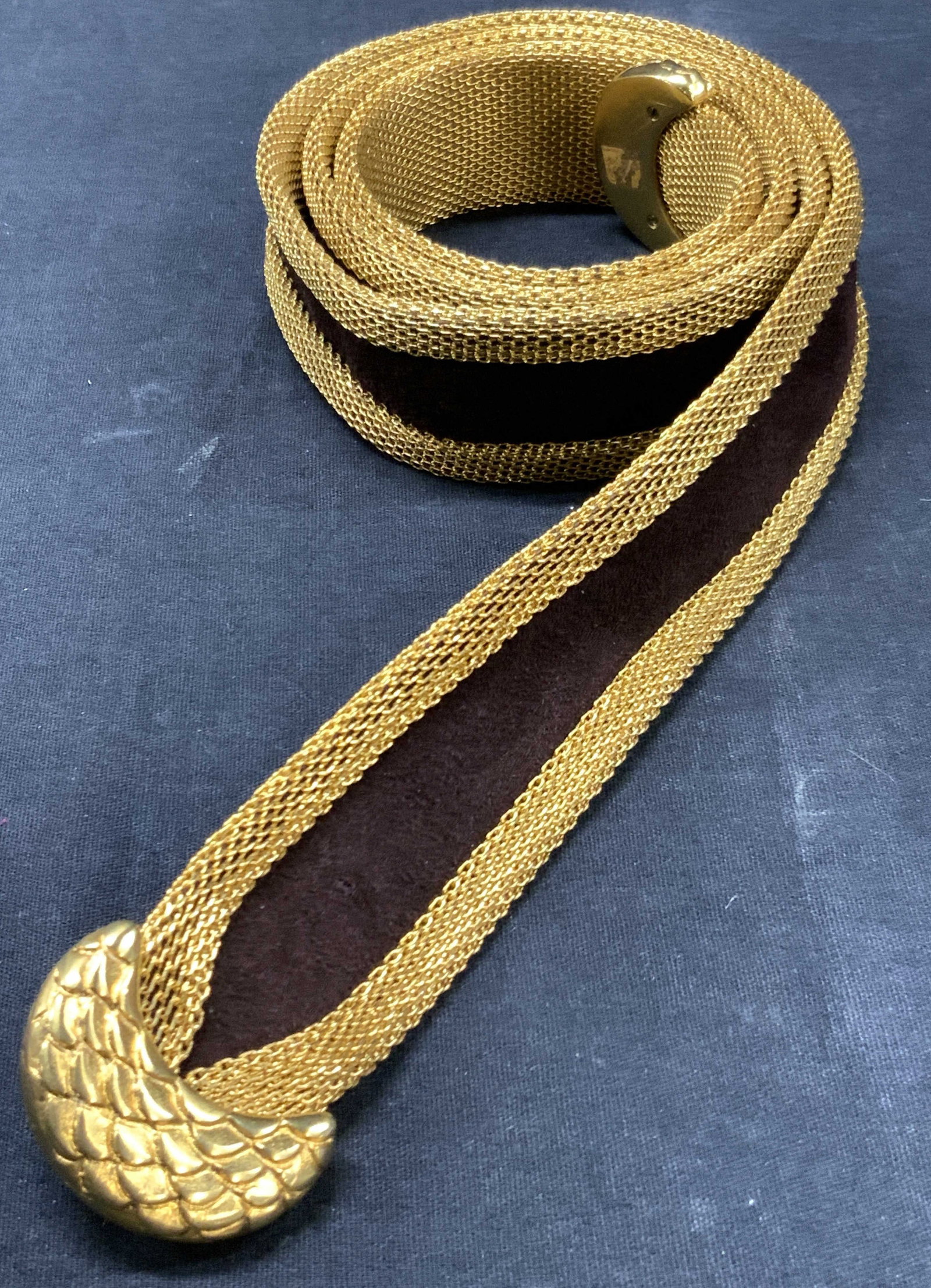 Gold Tn Metal Mesh & Suede Fashion Belt: Gold toned metal made belt with brown suede inner panel. Ends have snake skin like scales. Approx 43 inches long and 1.5 inch wide. Evident loss to buckle on one end and pitching of metal to body of t