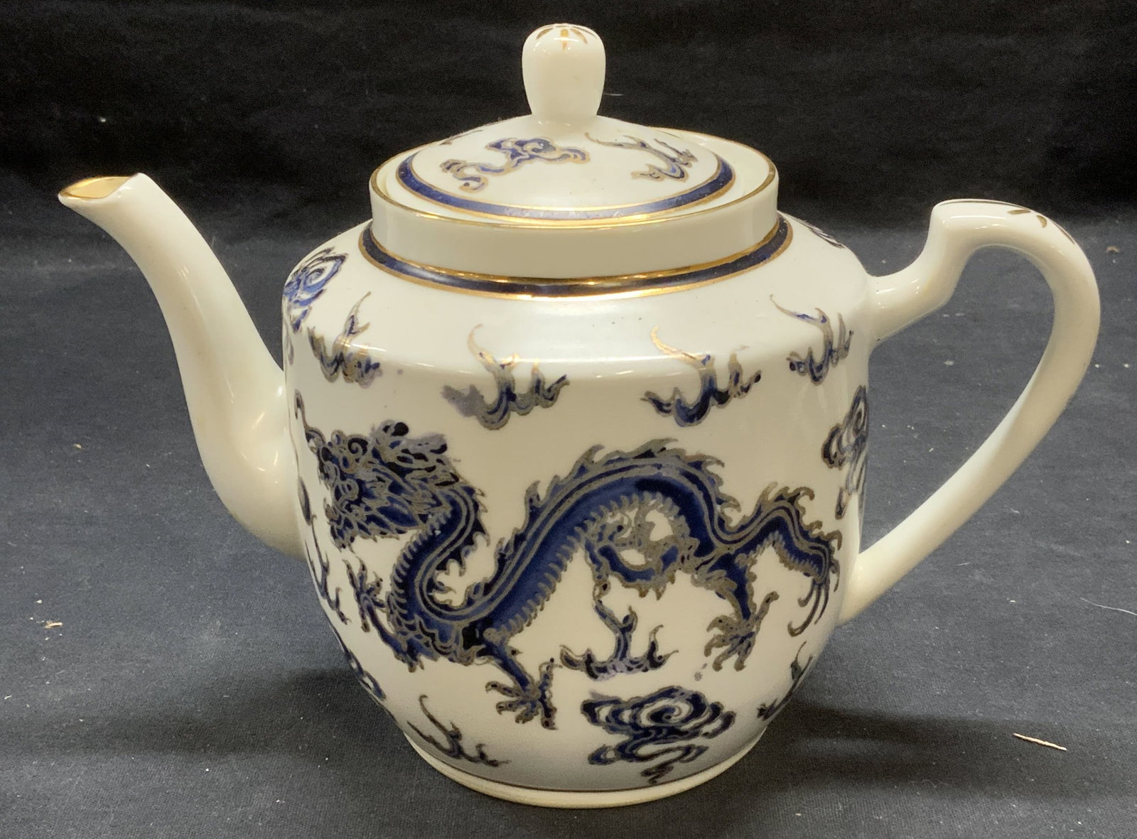 Vtg ACE Gilt Porcelain Asian Dragon Teapot: Vintage ACE porcelain teapot with hand painted and gilt decoration. Asian dragon motif. Trademarked to underside. Measures approx. 8.5 x 4.75 x 6.5 inches. Some surface wear including scratching and l