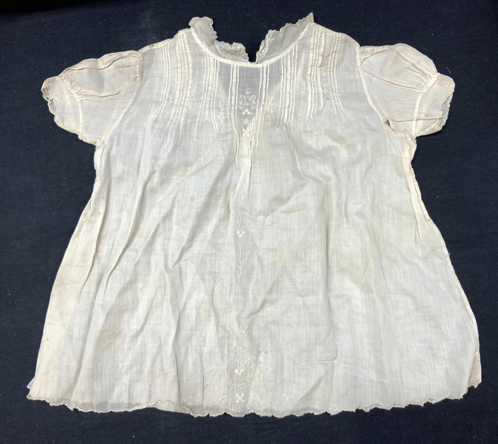 Antique Linen Baby Gown: Antique, possibly vintage white linen baby gown with button up collar. Approximately 17 inches off from collar to end of dress, sleeves measure 4 inches long and measures 12 inches wide at the chest.