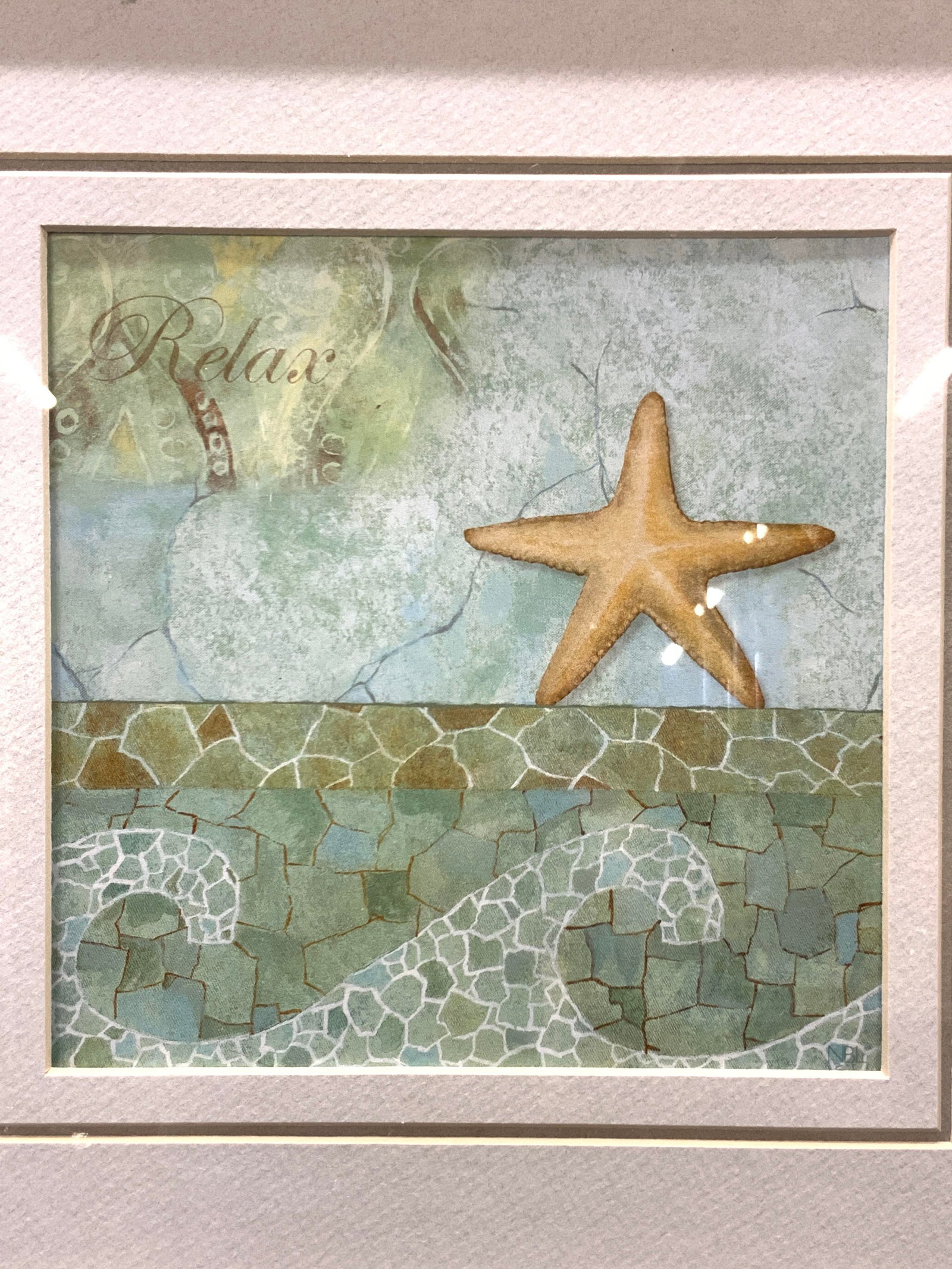 Framed Maritime Lithograph: Maritime lithograph depicting a starfish with the words Relax on upper left corner. Framed in gray toned wooden frame with light gray mat board. Approximately 15 x 15 inches window measures 7.25 x 7.2