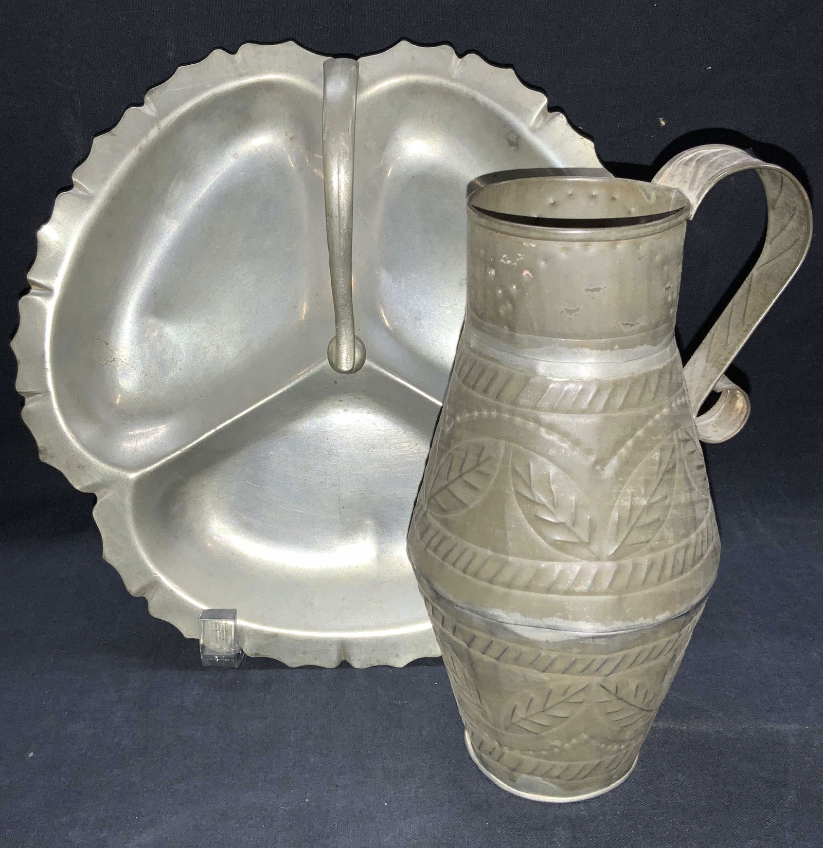 2 Vintage Pewter & Metal Table Accessories: Lot of 2 vintage metal accessories. 1 pewter tray in the shape of a clover with three sections and side handle. approximately 9.25 Inch diameter. 1 white metal made vessel with side handle and pressed