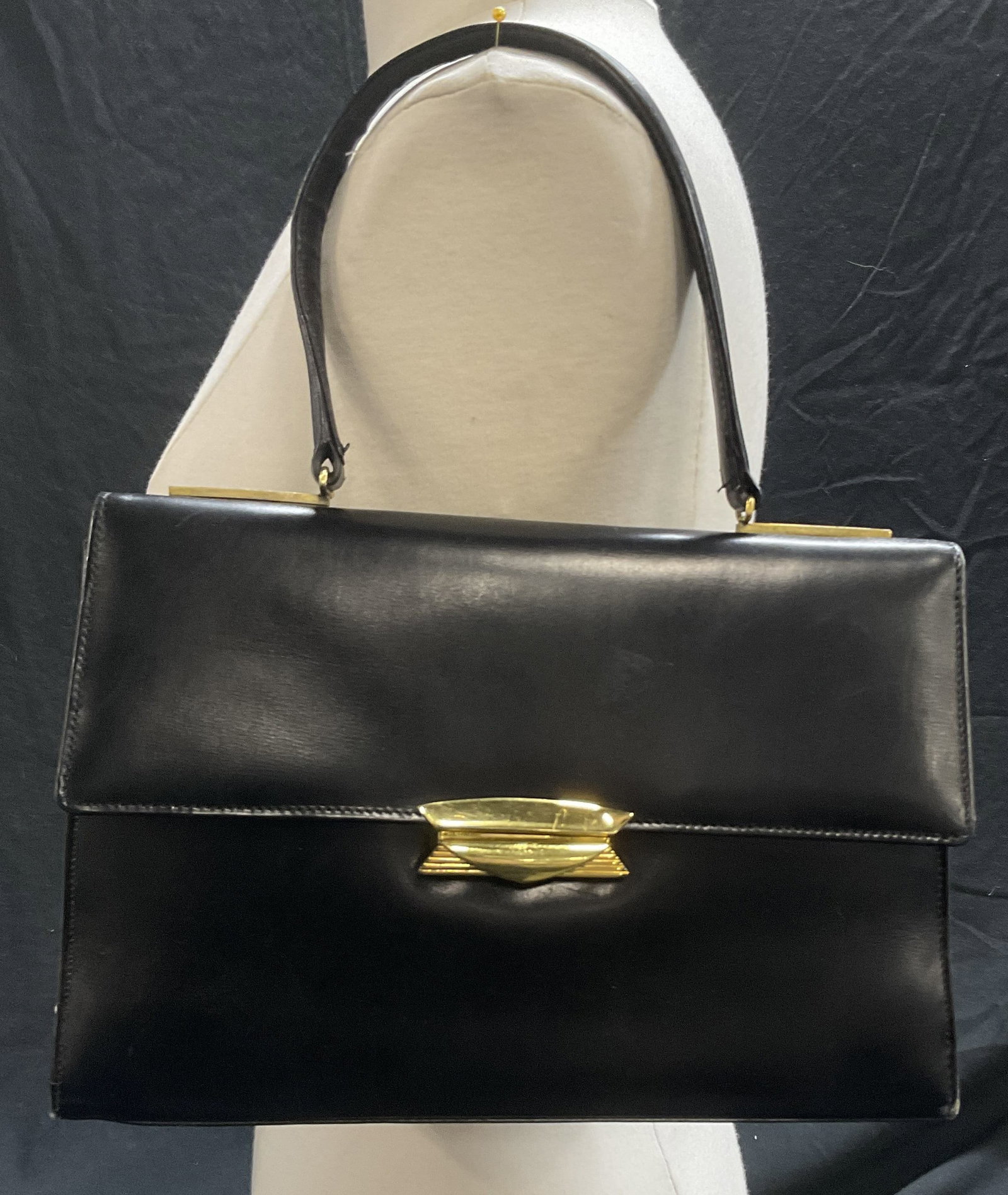 Vintage Arnold Constable Black Bag, France: Vintage Arnold Constable Top Handle Black Bag with gold tone hardware. Flap closure. Two interior pockets. Change purse in one pocket. Inside reads, Made in France Expressly for Arnold Constable Fifth