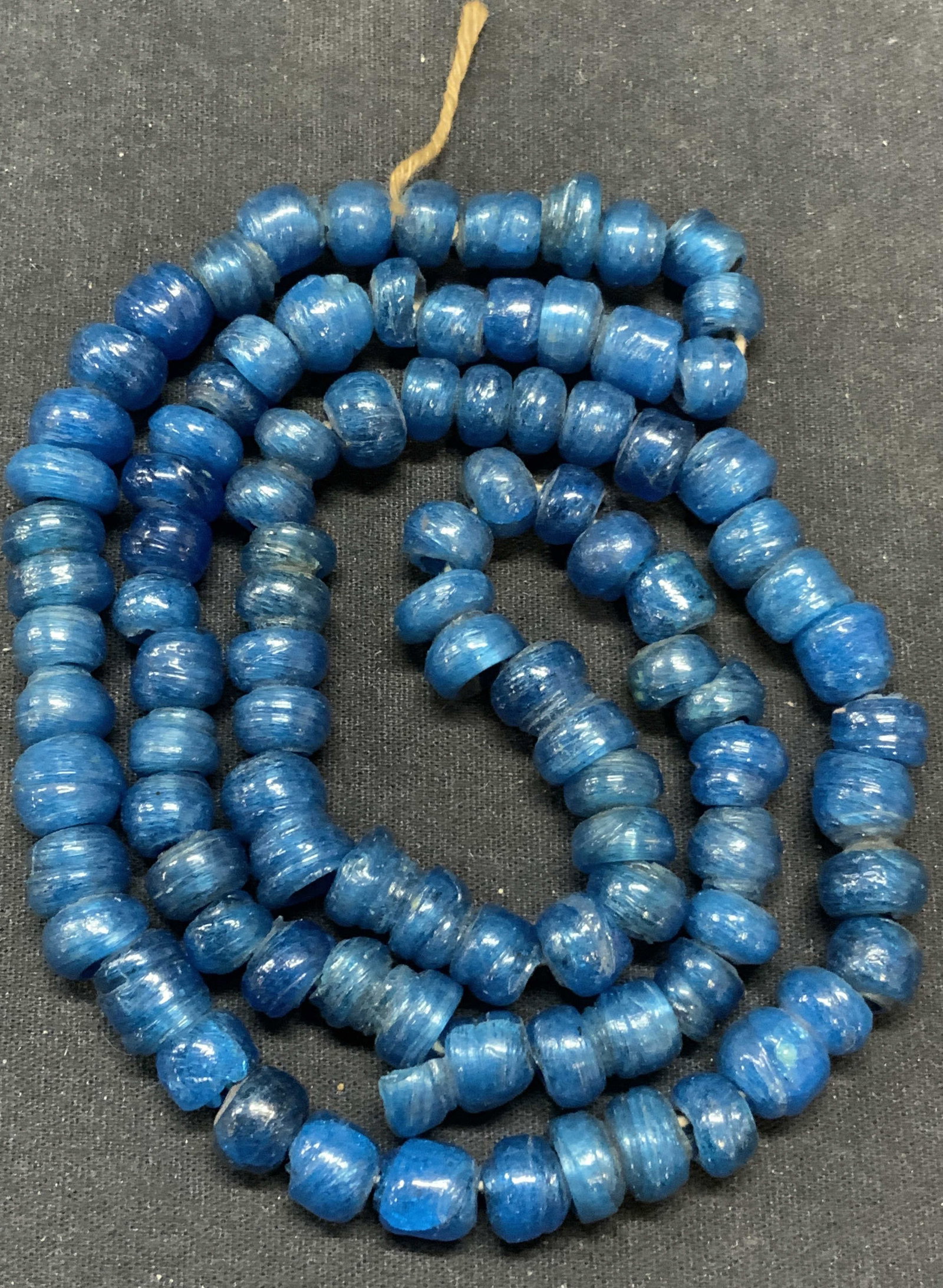 Vintage Blue Spun Glass Beaded Necklace: Vintage blue spun glass beaded necklace. Drop length approx. 14.5 inches. Surface wear consistent with exposure including scratching and chipping. Estate jewelry, costume jewelry, cocktail jewelry, fa