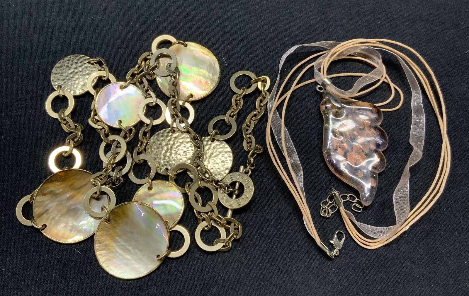 2 MONET Mother of Pearl Medallion Necklace, More: Lot of 2 jewelry pieces. Monet mother of pearl medallion necklace. Signed on clasp. Drop length approx. 18 inches, largest medallion approx. 1 3/8 inches diameter. Art glass pendant necklace on multi 