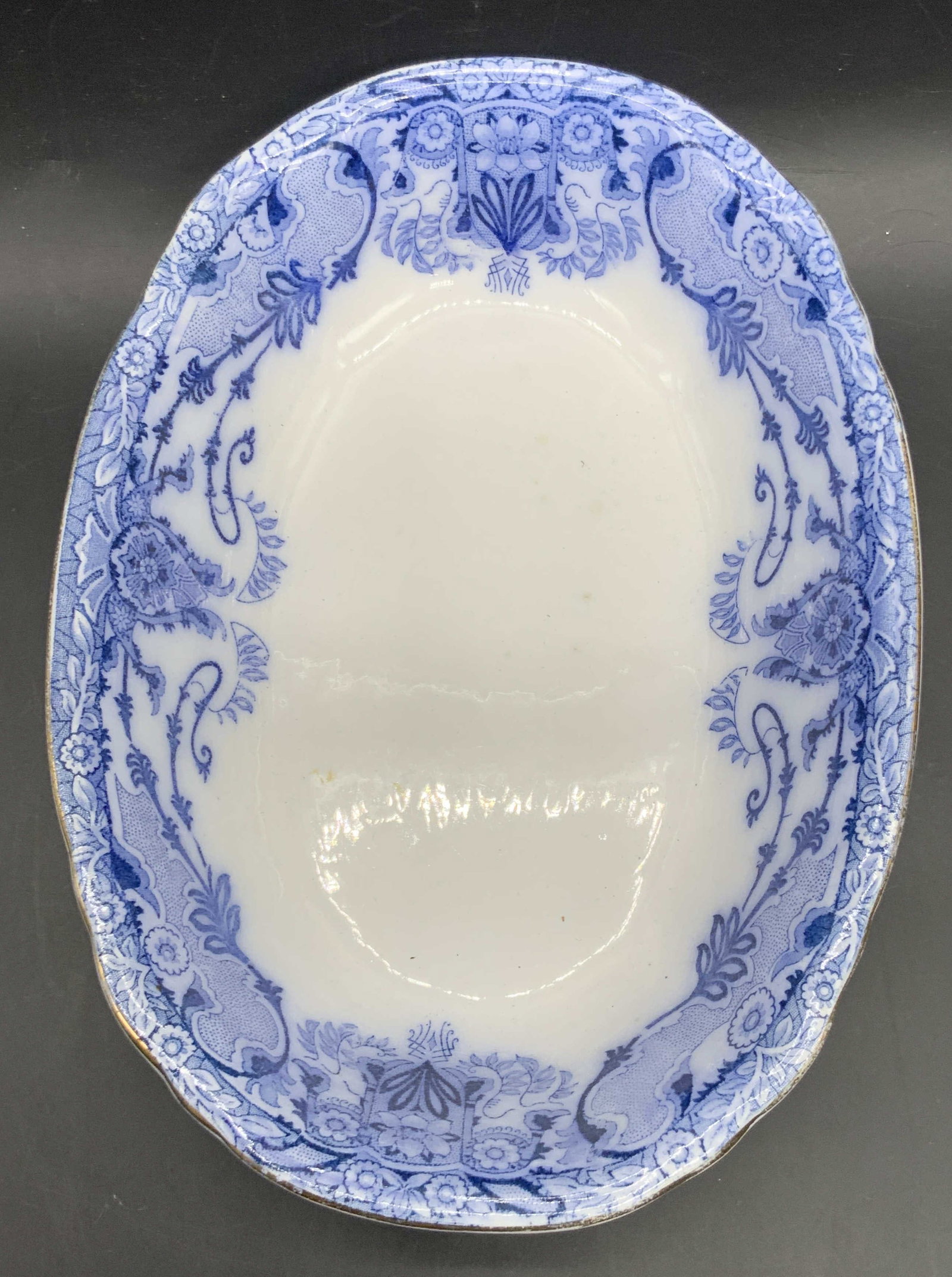 BURGESS & LEIGH Semi Porcelain English Bowl: Antique blue and white oval serving bowl with a gilt rim. Underside stamp reads SEMI PORCELAIN ENGLAND, BURGESS & LEIGH COALPORT POTTERY, RALEIGH, B A N 393237. Underside stamp is worn. Impressed with