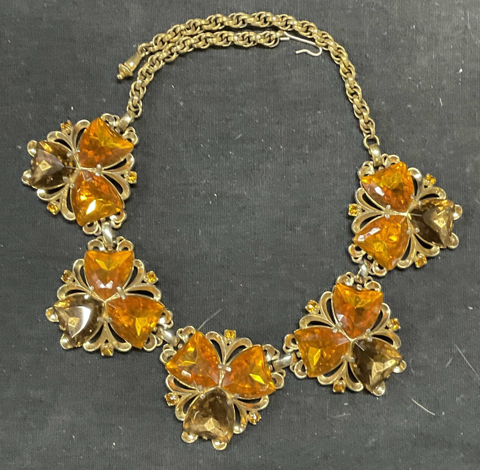 Vintage SCHIAPARELLI Gold Tn Crystal Necklace: Vintage Schiaparelli gold tone necklace. Orange and brown toned crystal decorated pendants. Signed to underside. Drop length approx. 6.5 inches. Includes jewelry box. Some scratching observed. Estate 