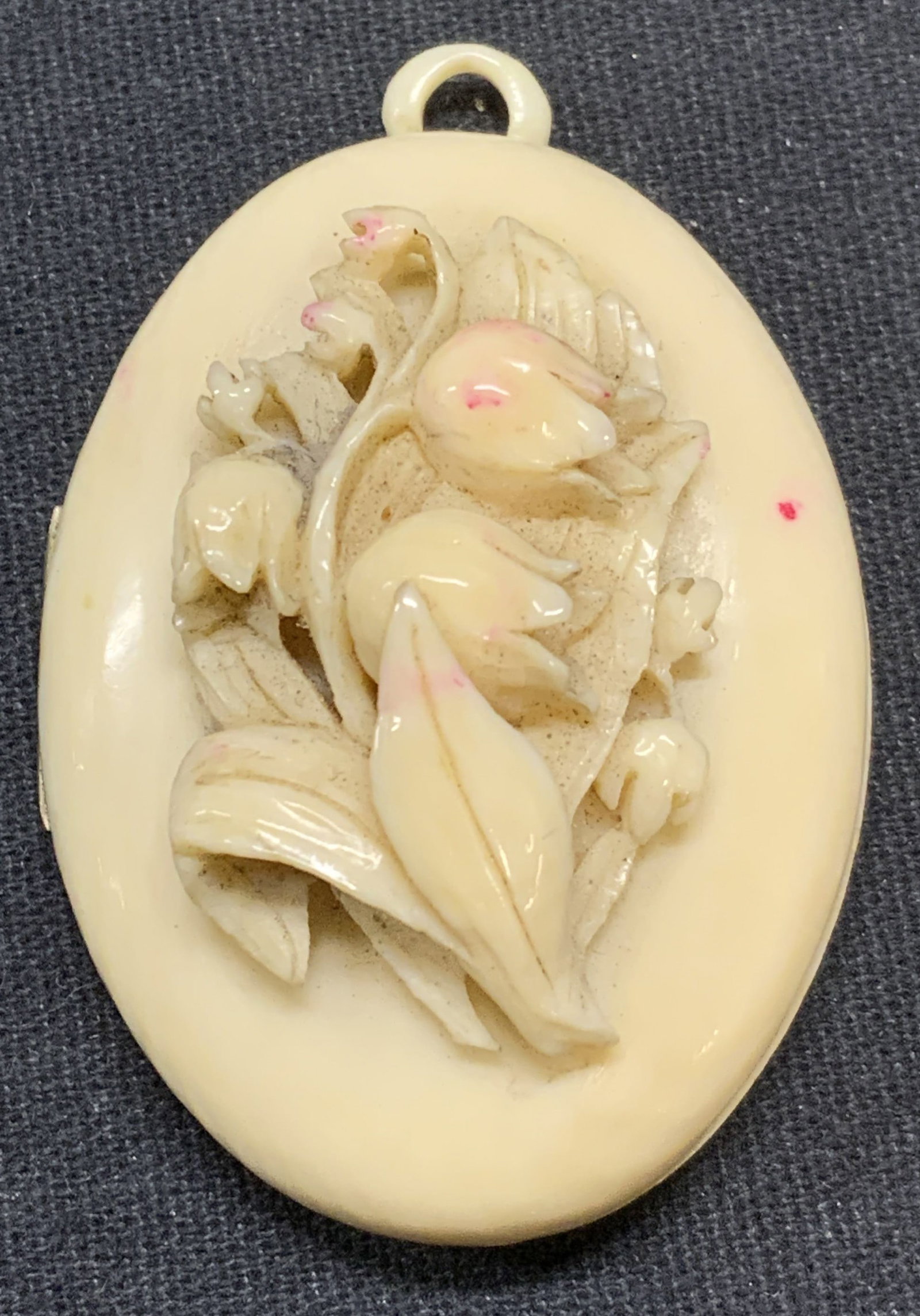 Vintage Carved White Flower Locket Pendant: Vintage white carved flower locket pendant. Possibly bone. Measures approx. 1.75 x 1.25 inches. Some surface wear including scratching and marks observed. Property of Greenwich Connecticut estate. Own