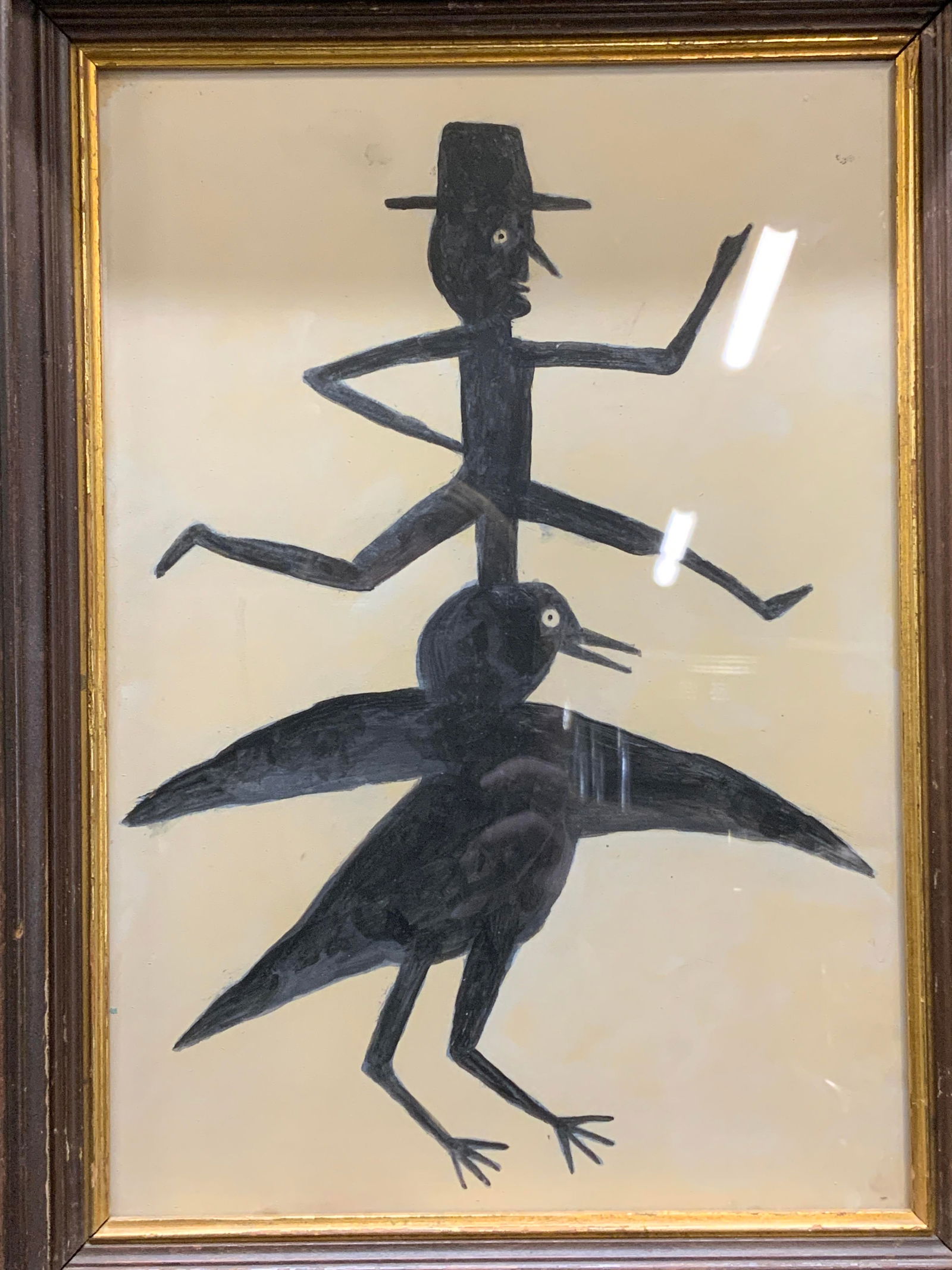 Attr Bill Traylor Man & Crow Tempera Painting 16in: Attributed Bill Traylor (American 1854-1949) tempera on cardboard painting. Subject depicts man in hat on top of crow in black. Signed to reverse. Framed in brown and gilt wood frame. Measures approx.