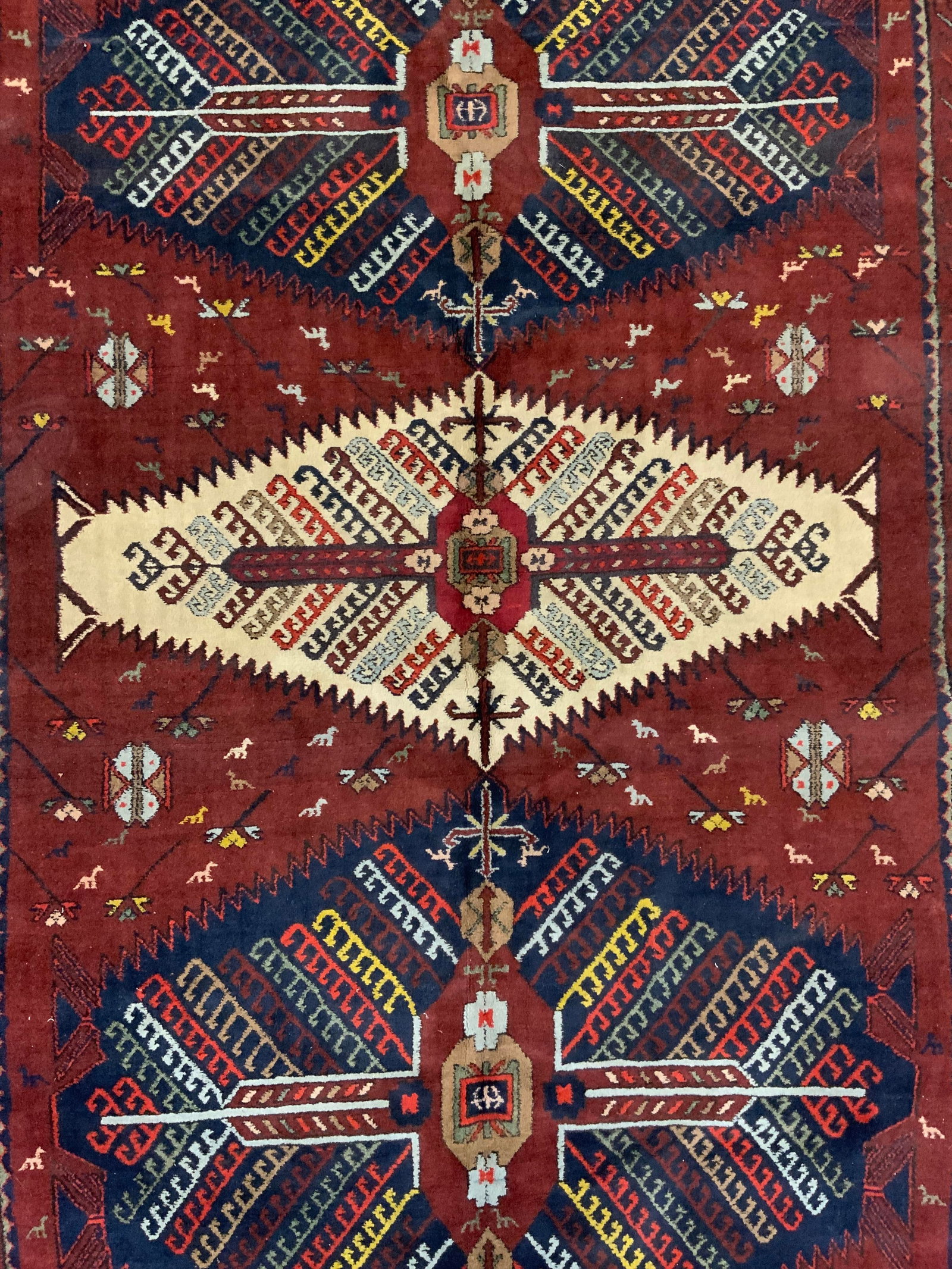 Vintage Handmade Turkish Wool Rug: Rug is handmade and wool. Piece is vintage, appears to be Turkish. Rug has intricate multi toned geometric detail. Measures approximately 95 inches long 59 inches wide. Edges have short cream toned fr