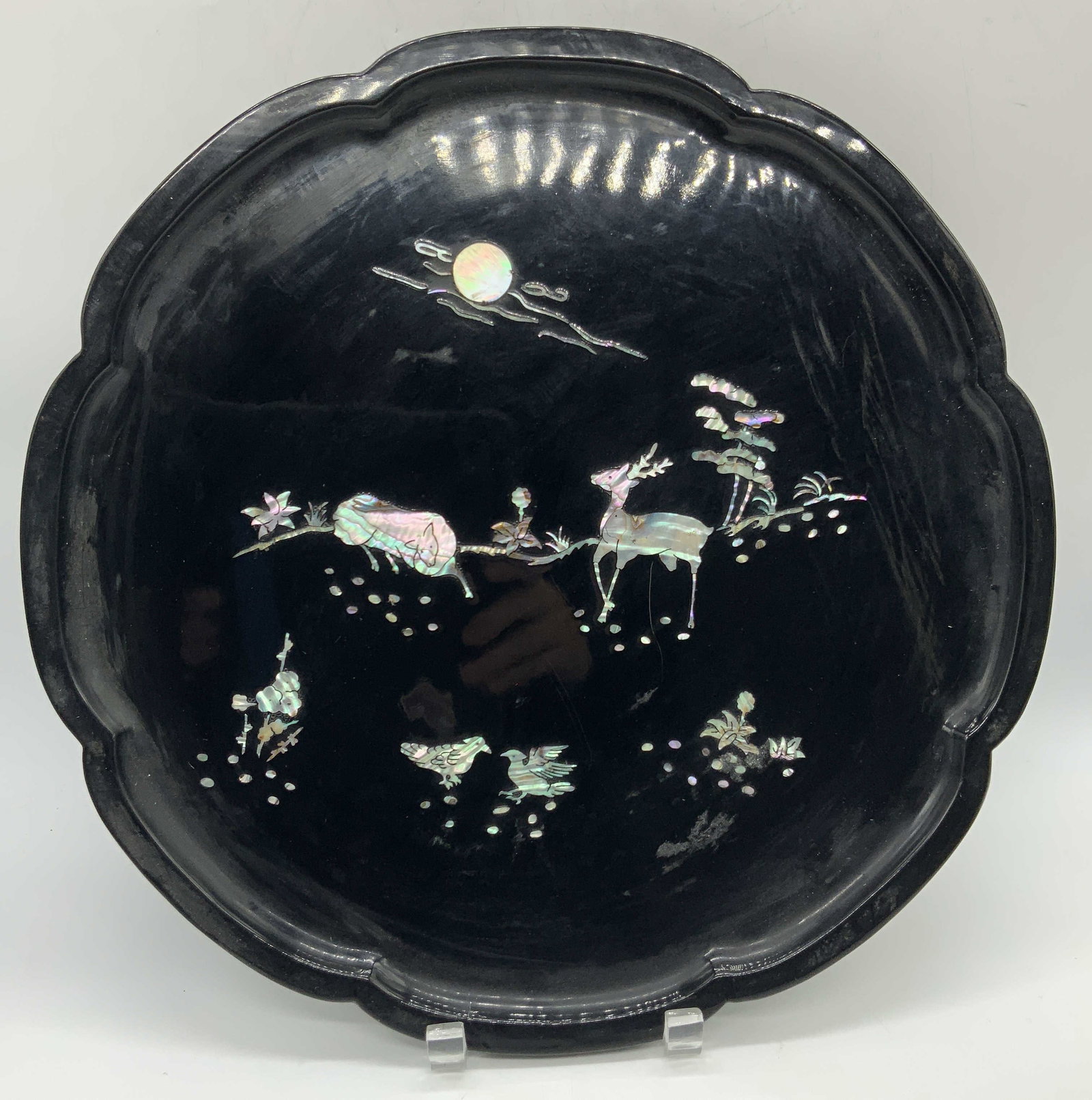 Vintage Lacquered Wood &Mother-of-pearl Platter 14in: Vintage black lacquered wooden platter with deer images made of mother of Pearl inlays. Approx 14 inch diameter. Moderate wearing to lacquer on wood and scratches observed, Lacquered wood platter, mot