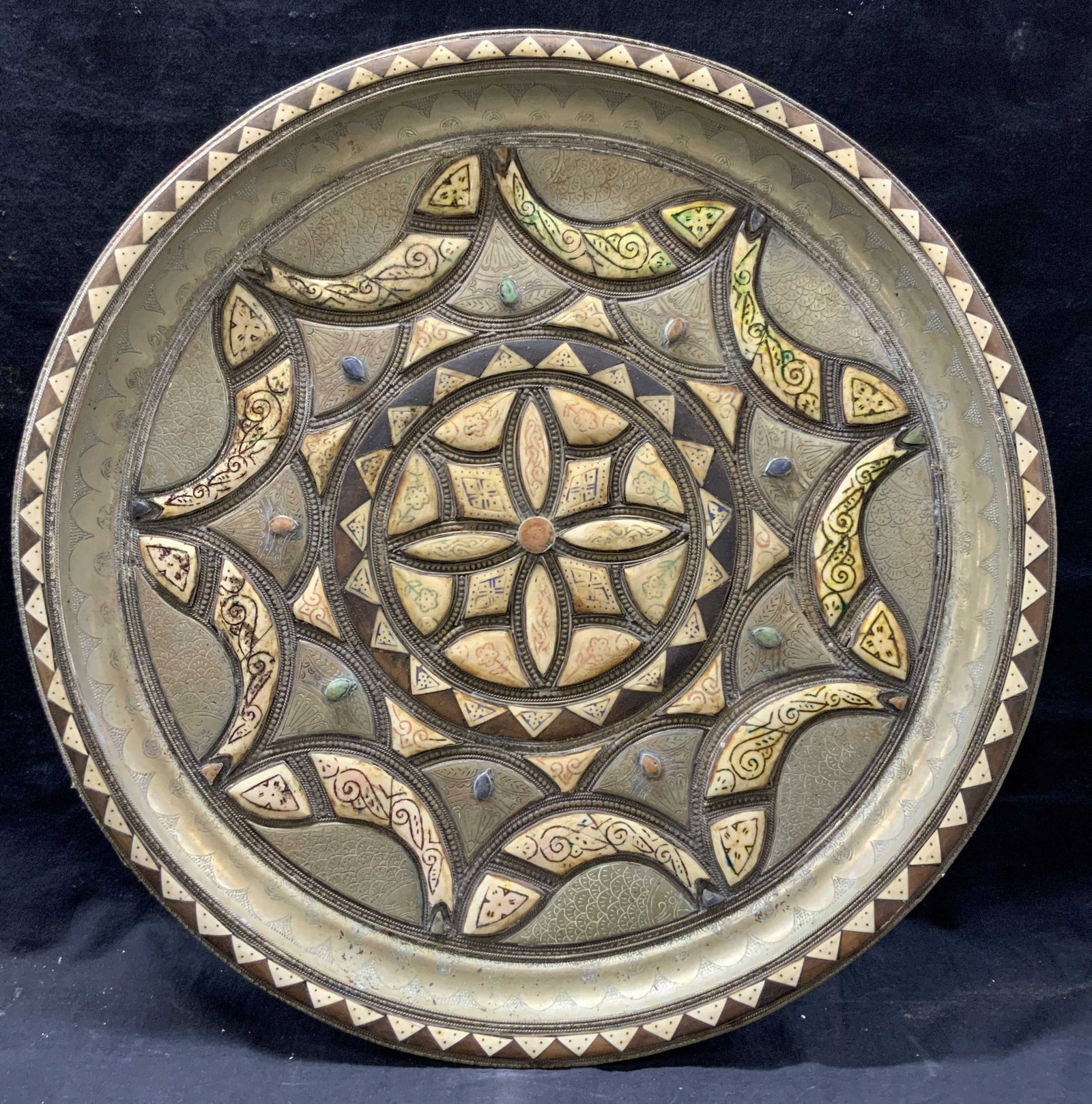 Antq Etched Brass, Bone & Stone Platter 2ft: Antique etched brass made platter with embossed fish motifs with etched detailing, Inlayed bone with colored etchings of flowers with center mandala style made of Inlayed bone and embedded stones in b
