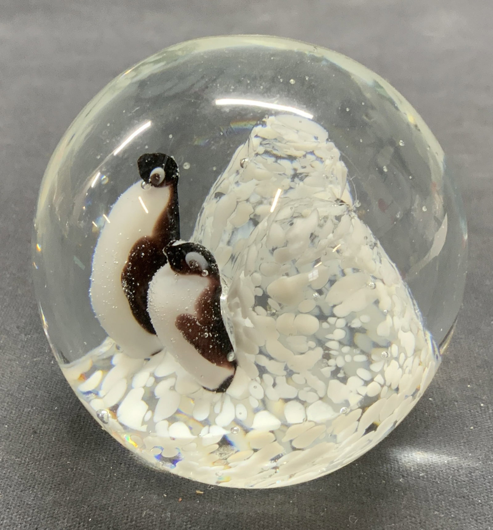 Hand Blown Art Glass Penguin Figurals Paperweight: Hand Blown Art glass paperweight with penguin motif. Hues of black and white. Measures approx. 2.5 x 2.5 inches. Some surface wear including scratching observed. Art glass, art glass paperweight, hand