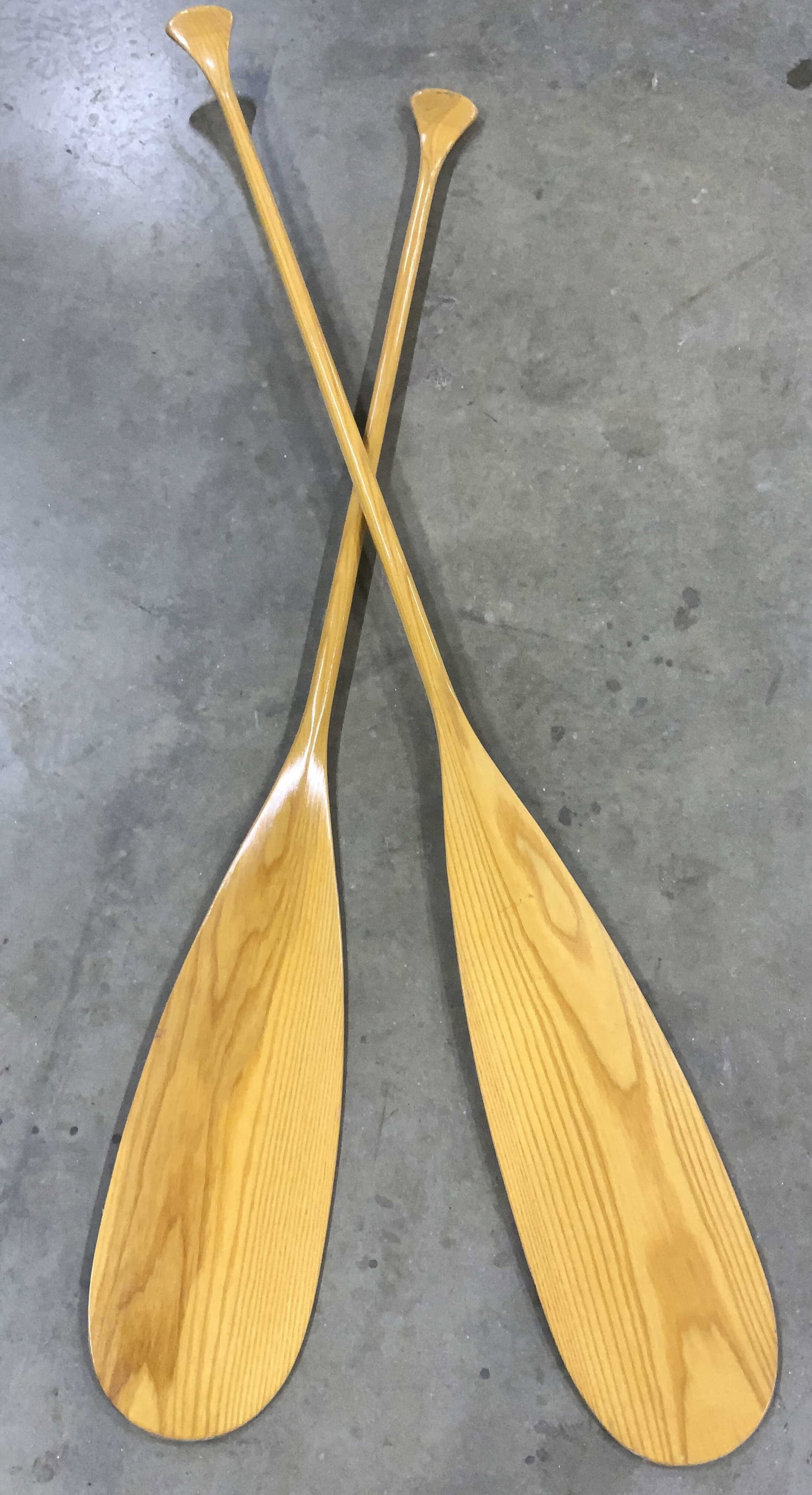 Pair OLD TOWN Shellacked Wood Paddles / Oars 57in: Finished oak wood oars signed OLD TOWN. Gently used. Paddle measures 20 x 7.5 in. W. Total length 57 in. Long. for 1 oar. The other measures 62.5 in. L . Light wear along paddle rim and on handles. Ca