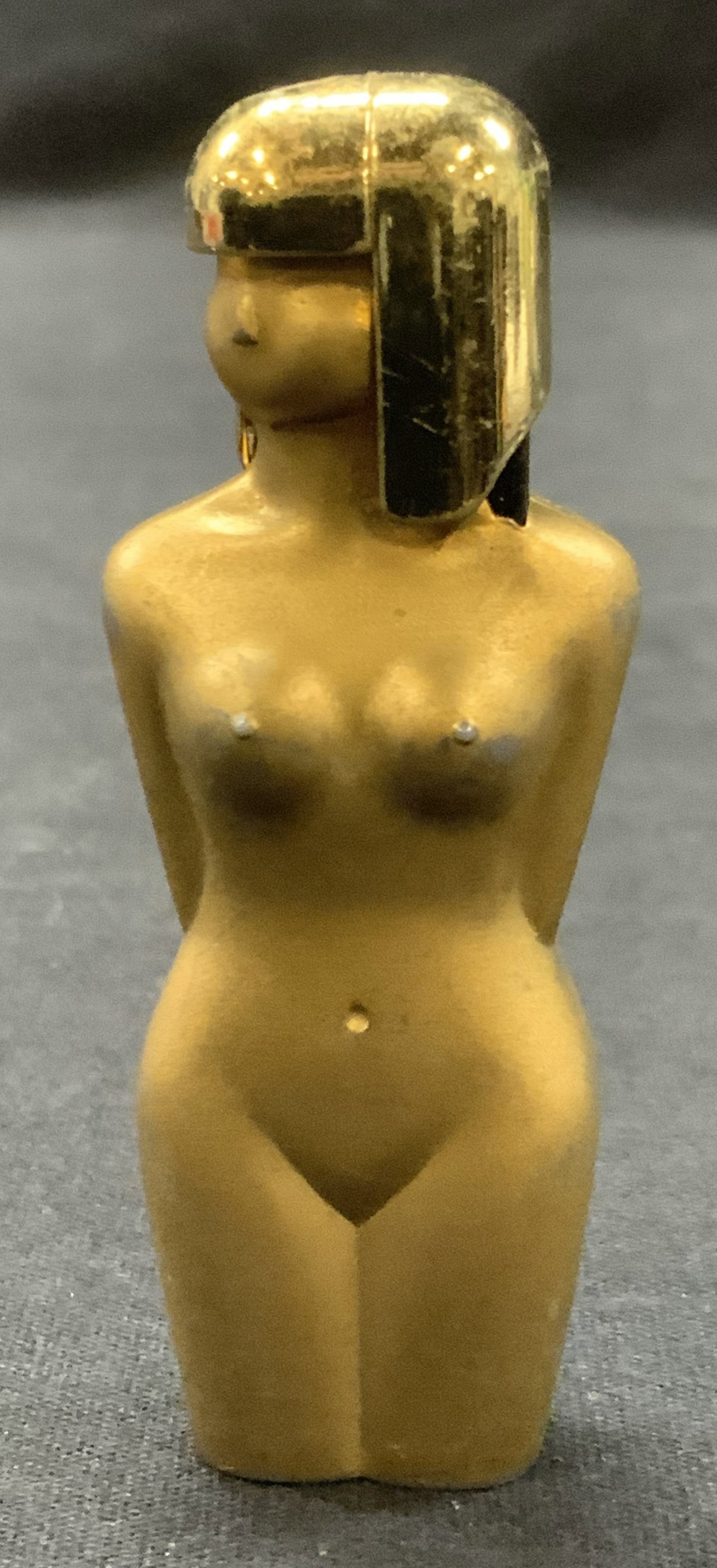 Vntg Nesor Japan Egyptian Style Nude Figure Lighter: Vintage gold toned female figure with Egyptian style hair. Marked on underside Nesor Japan. Approx 3 inches tall. Evident wearing to gold tone throughout. Not tested for functionality. Vintage lighter