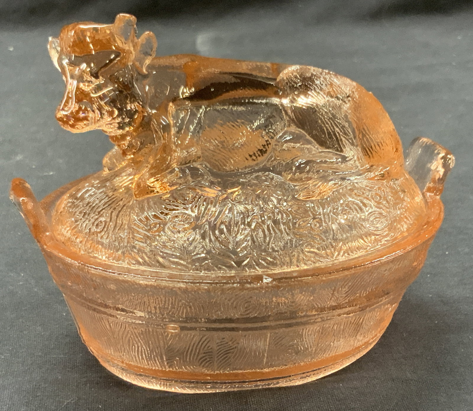Vintage Pink Tn Nesting Cow Depression Glass Vessel: Vintage pink toned depression glass nesting cow vessel with the figure of laying cow a barrel of hay. Approx 4.25 inches tall and 5 inch diameter. Minor wearing to glass and loss to edges of glass Col